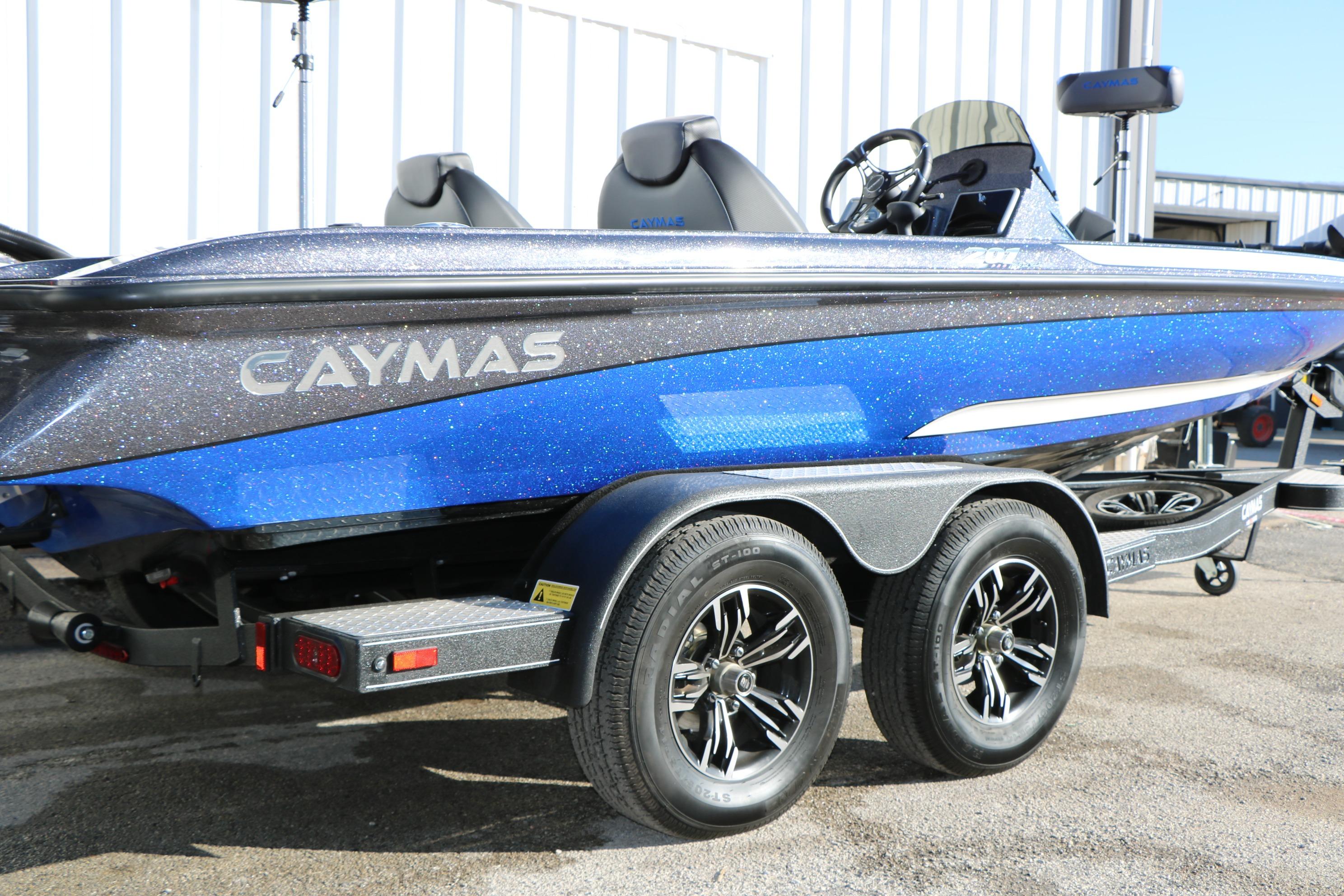 2027 Caymas 201 Pro boat in blue, on a trailer, parked outdoors.