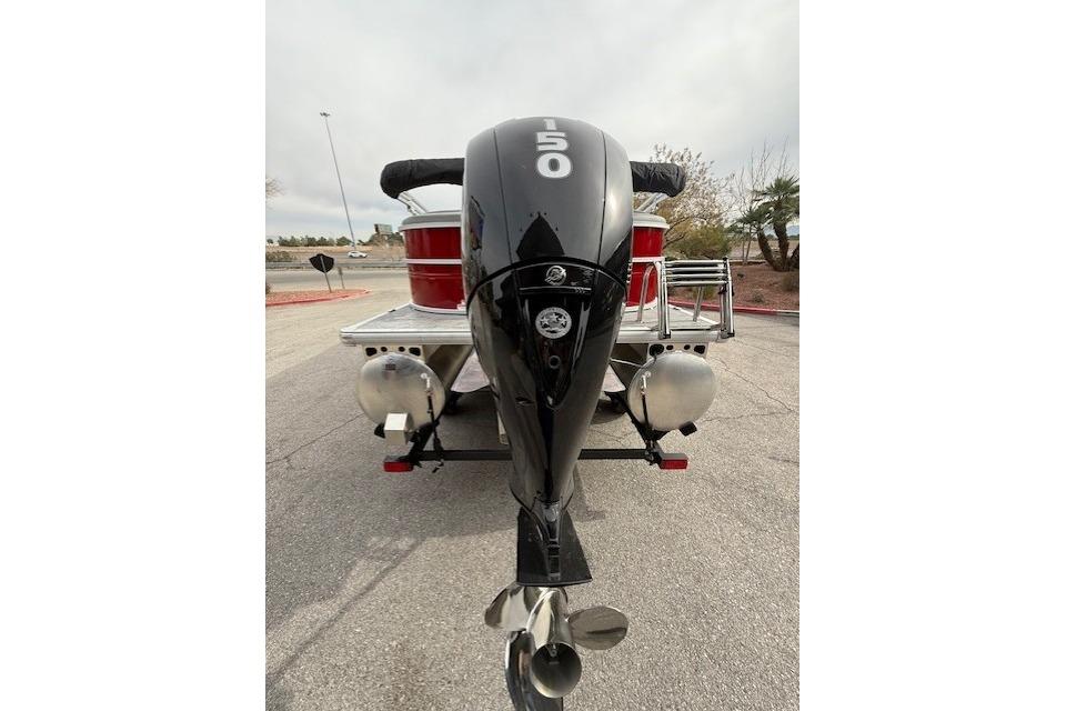2026 Sun Tracker Party Barge 22 DLX with powerful 150 HP outboard motor.