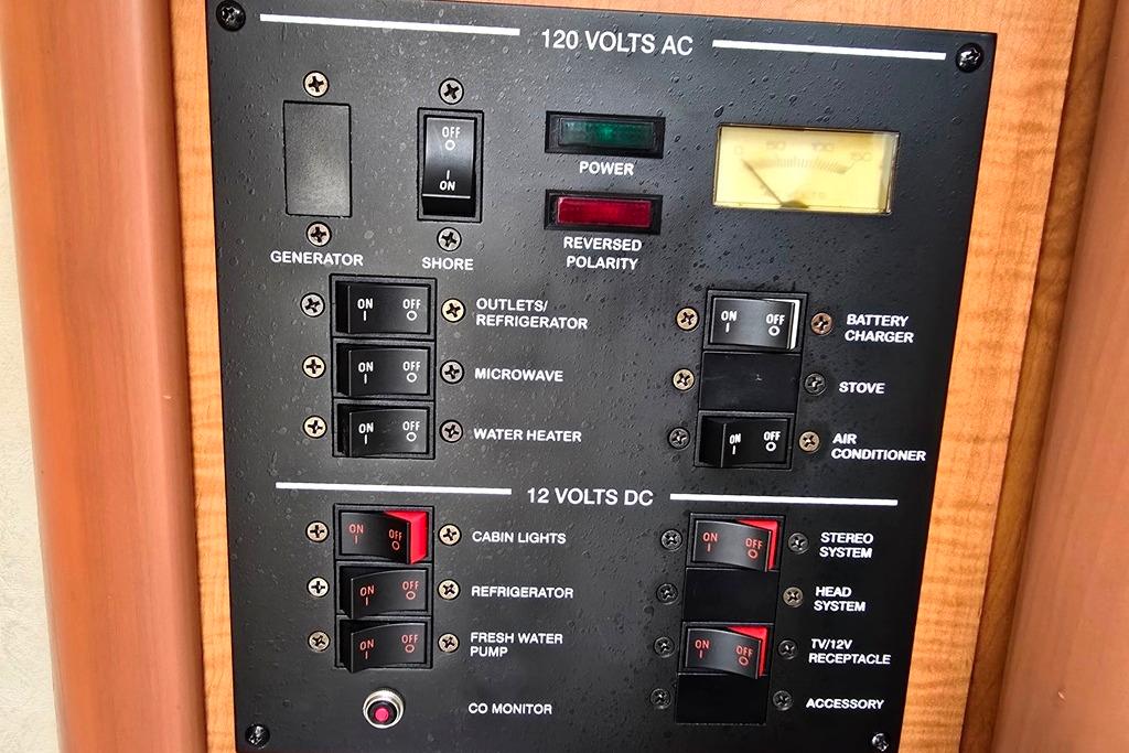 Electrical control panel of a 2006 Sea Ray 240 Sundancer boat, featuring AC and DC switches.