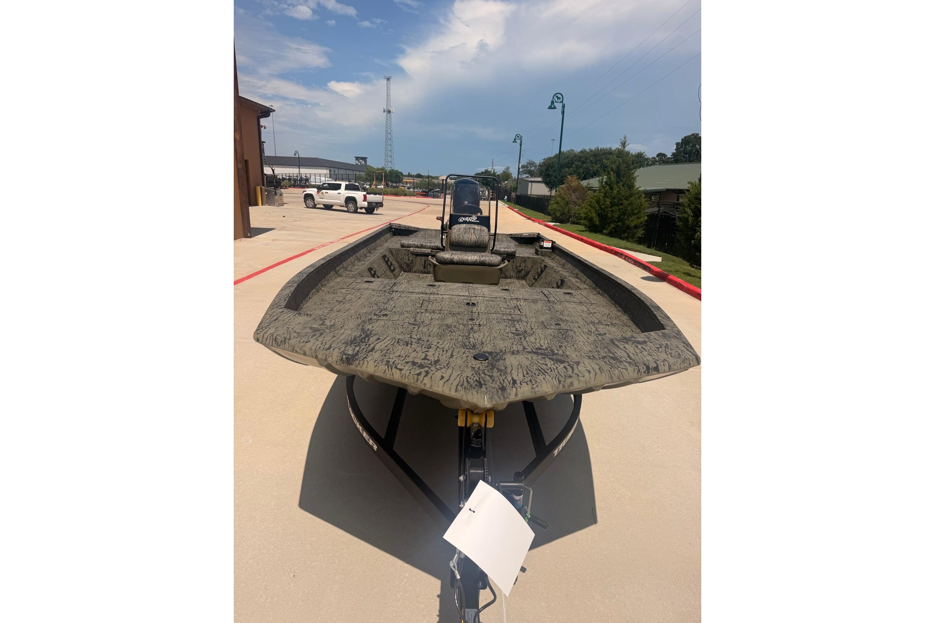2026 Tracker Grizzly 2072 CC boat on trailer, parked outdoors under a clear sky.