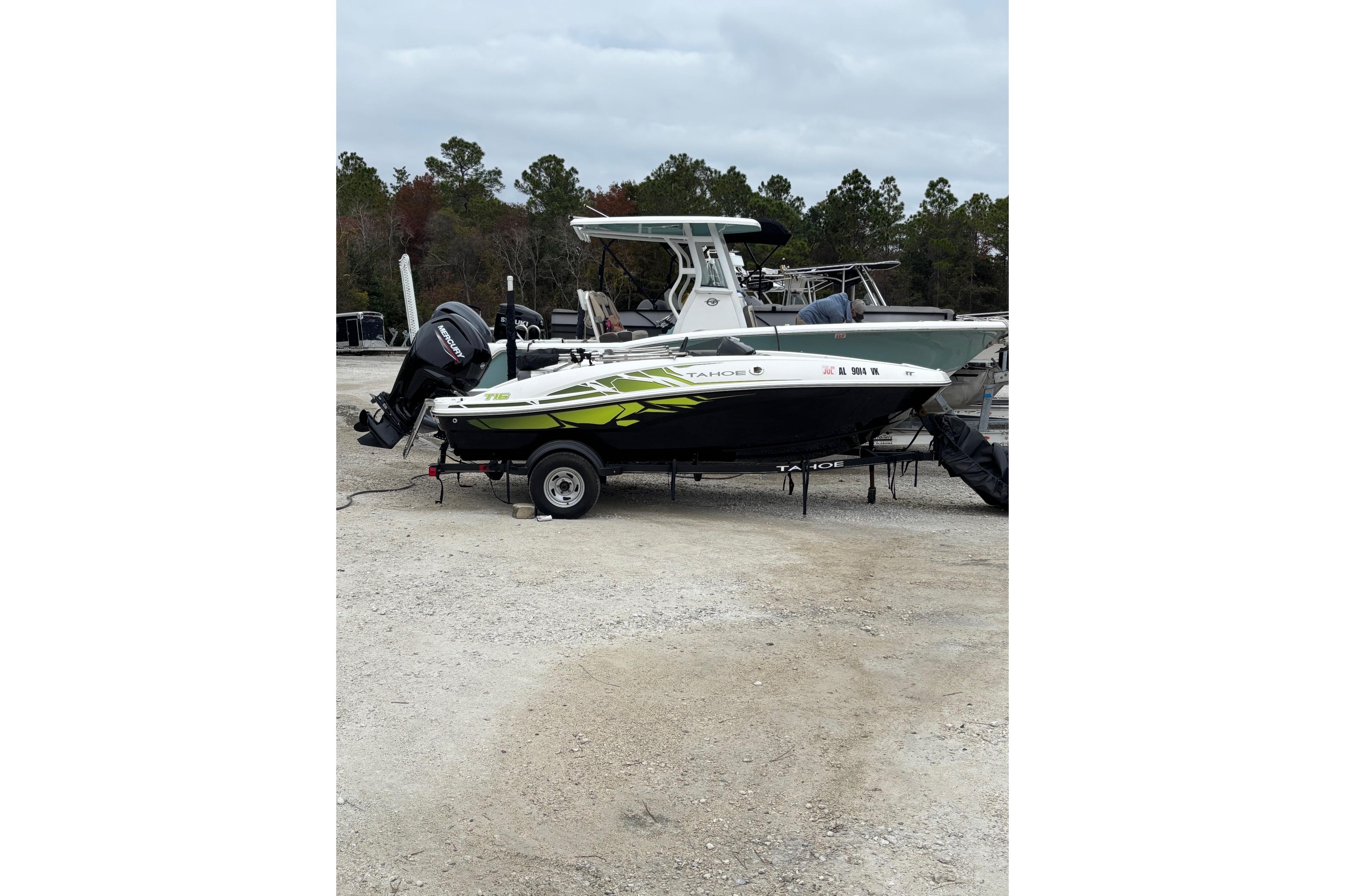2022 Tahoe T16 boat on trailer, parked outdoors with trees in background.