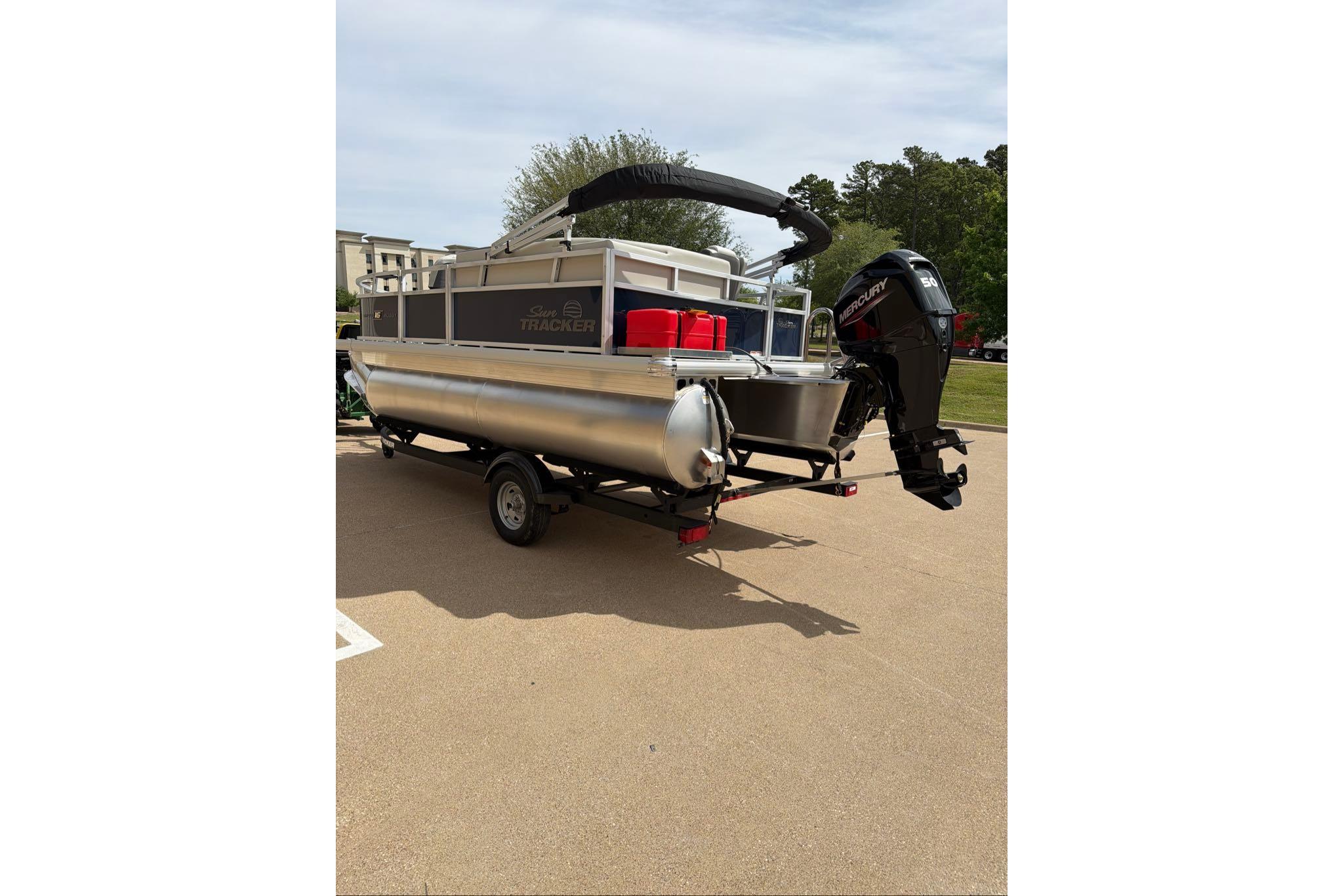 2026 Sun Tracker Bass Buggy 16 XL Select pontoon boat on trailer, rear view.
