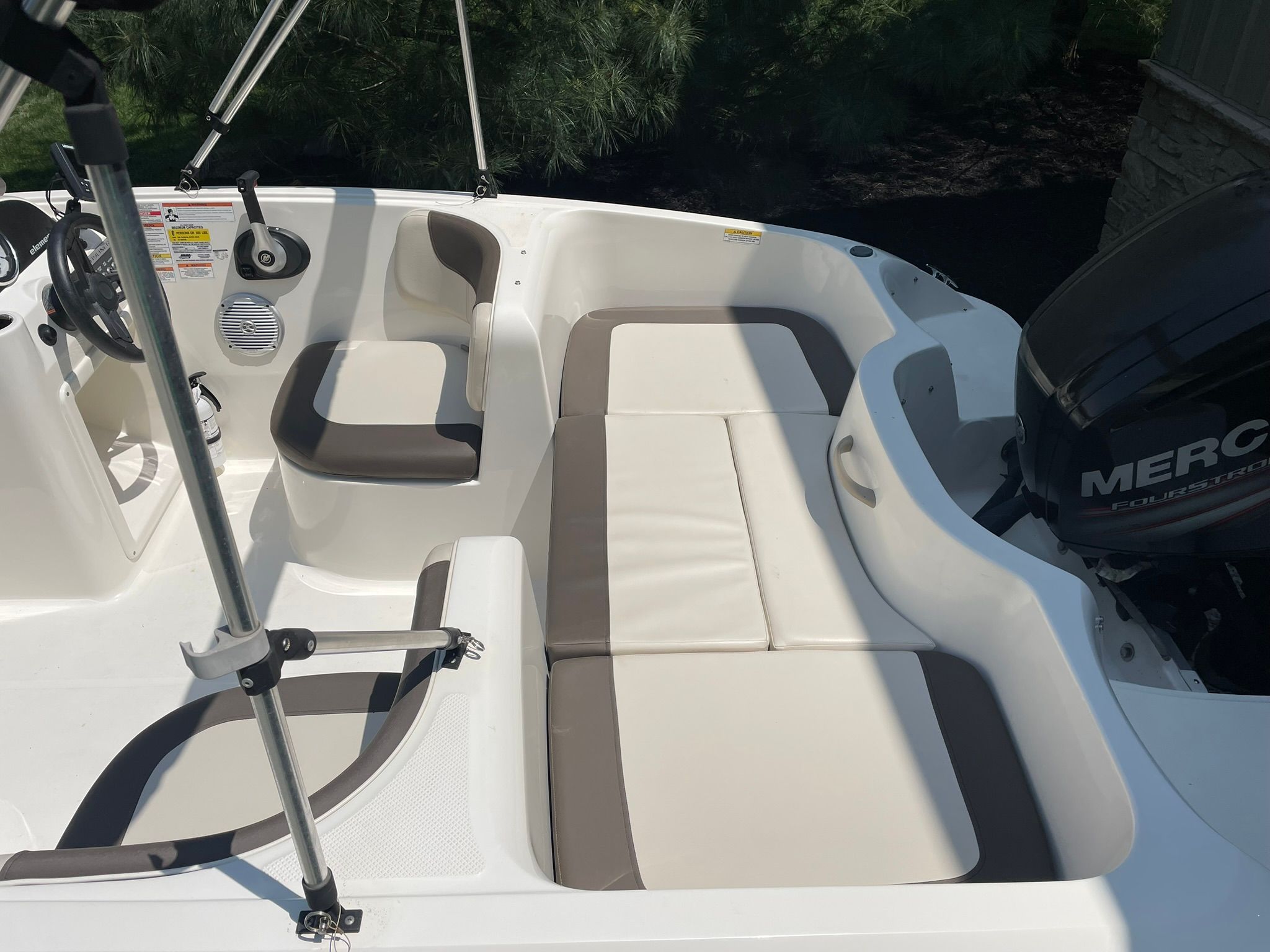 Interior view of a 2018 Bayliner 160 Bowrider with seating and helm station.