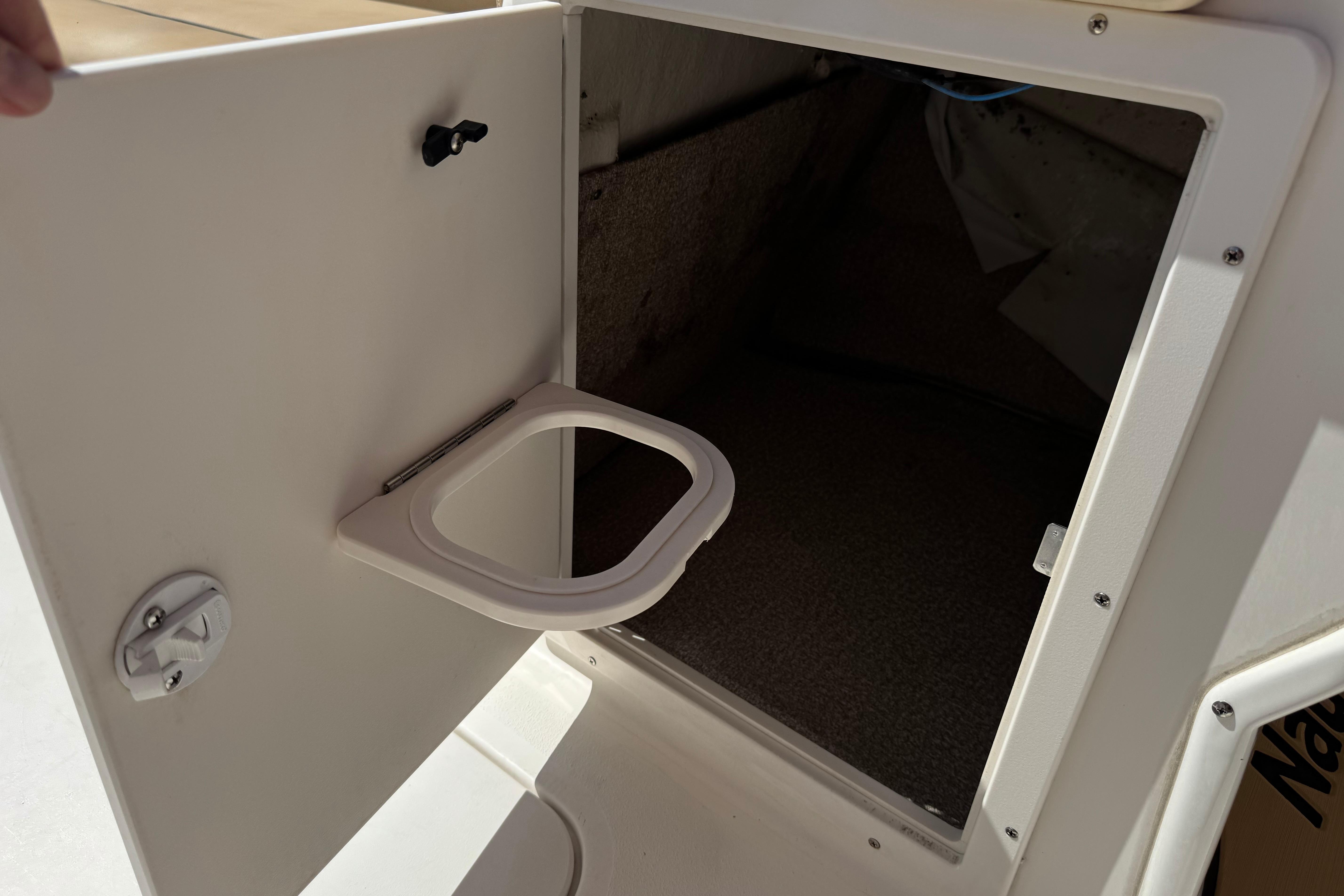 Open storage compartment on a 2020 NauticStar 203 SC boat.
