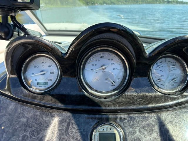 Dashboard of a 2009 Monterey 234FS with gauges and water in the background.