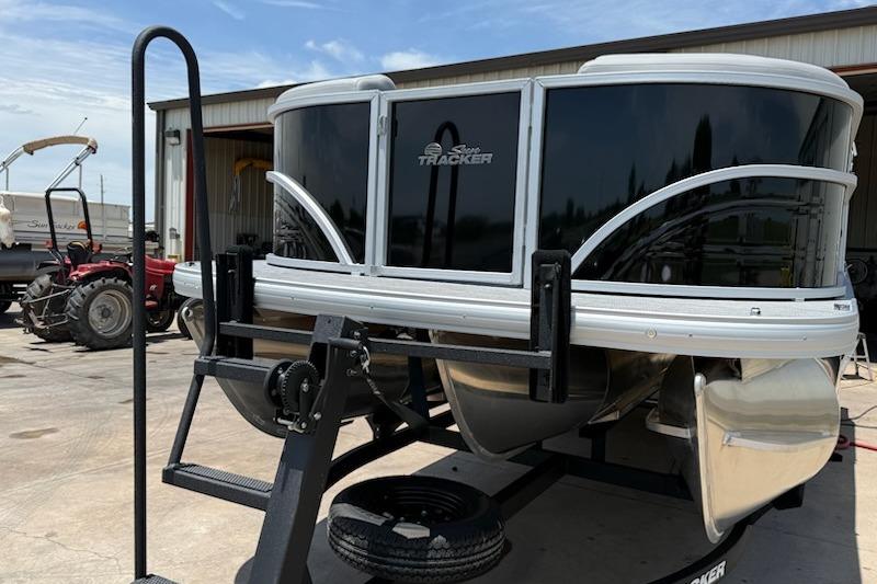2026 Sun Tracker Party Barge 22 XP3 pontoon boat on trailer, parked outdoors.