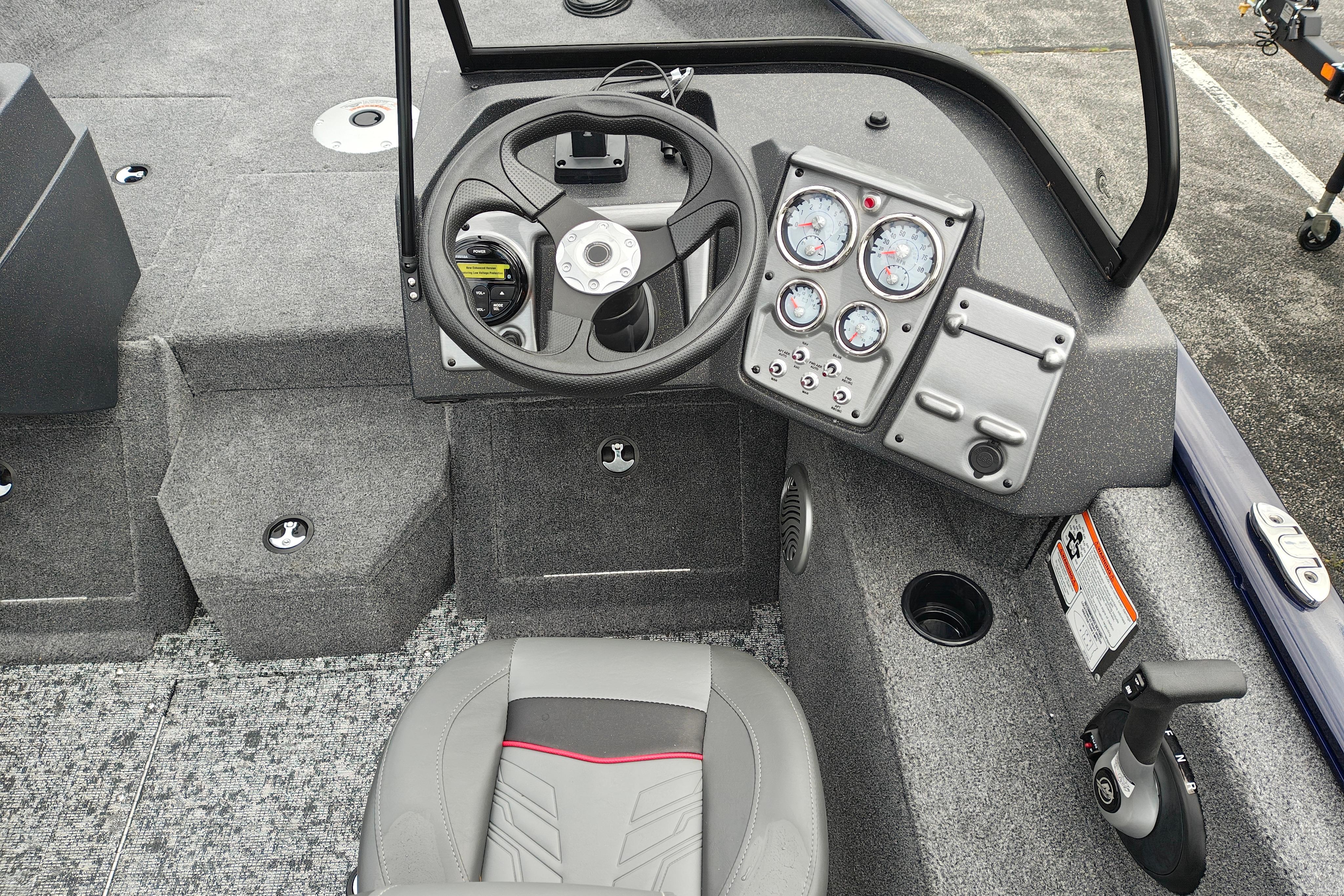 Interior of 2026 Tracker Pro Guide V-175 WT boat, featuring steering wheel and control panel.