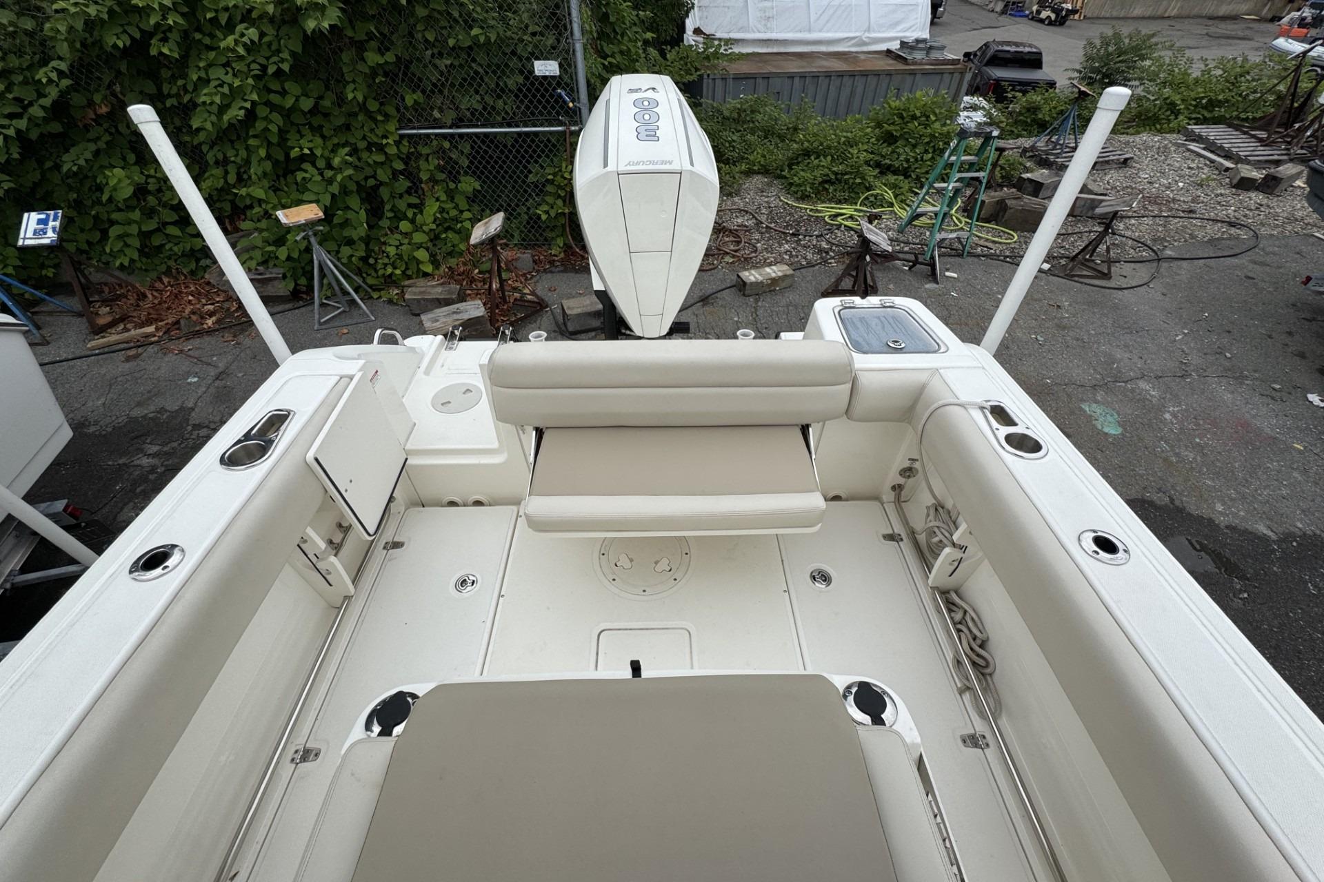 2024 Boston Whaler 230 Outrage boat interior with seating and engine view.