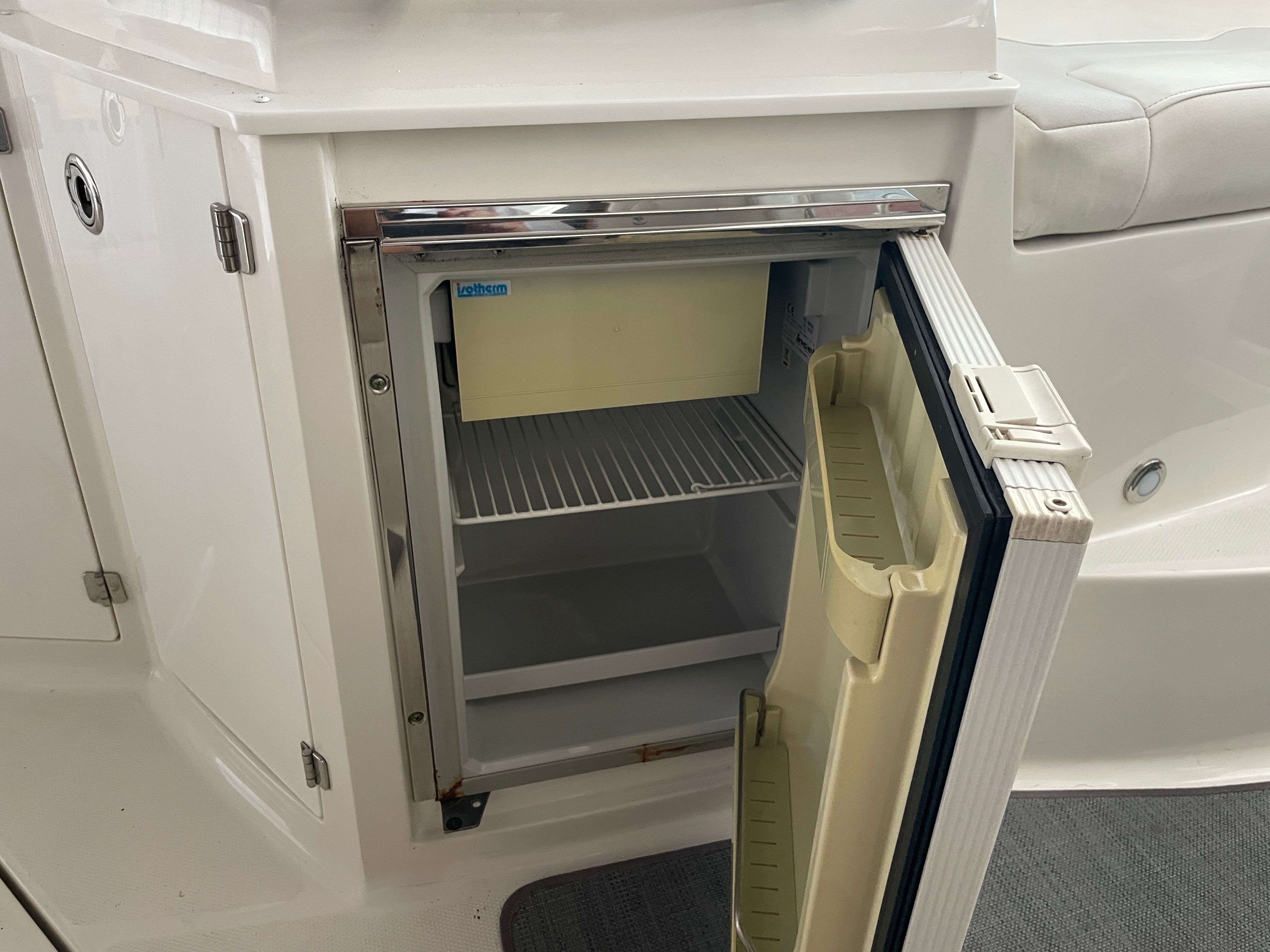 Open fridge on a Monterey 280 Sport Cruiser boat.