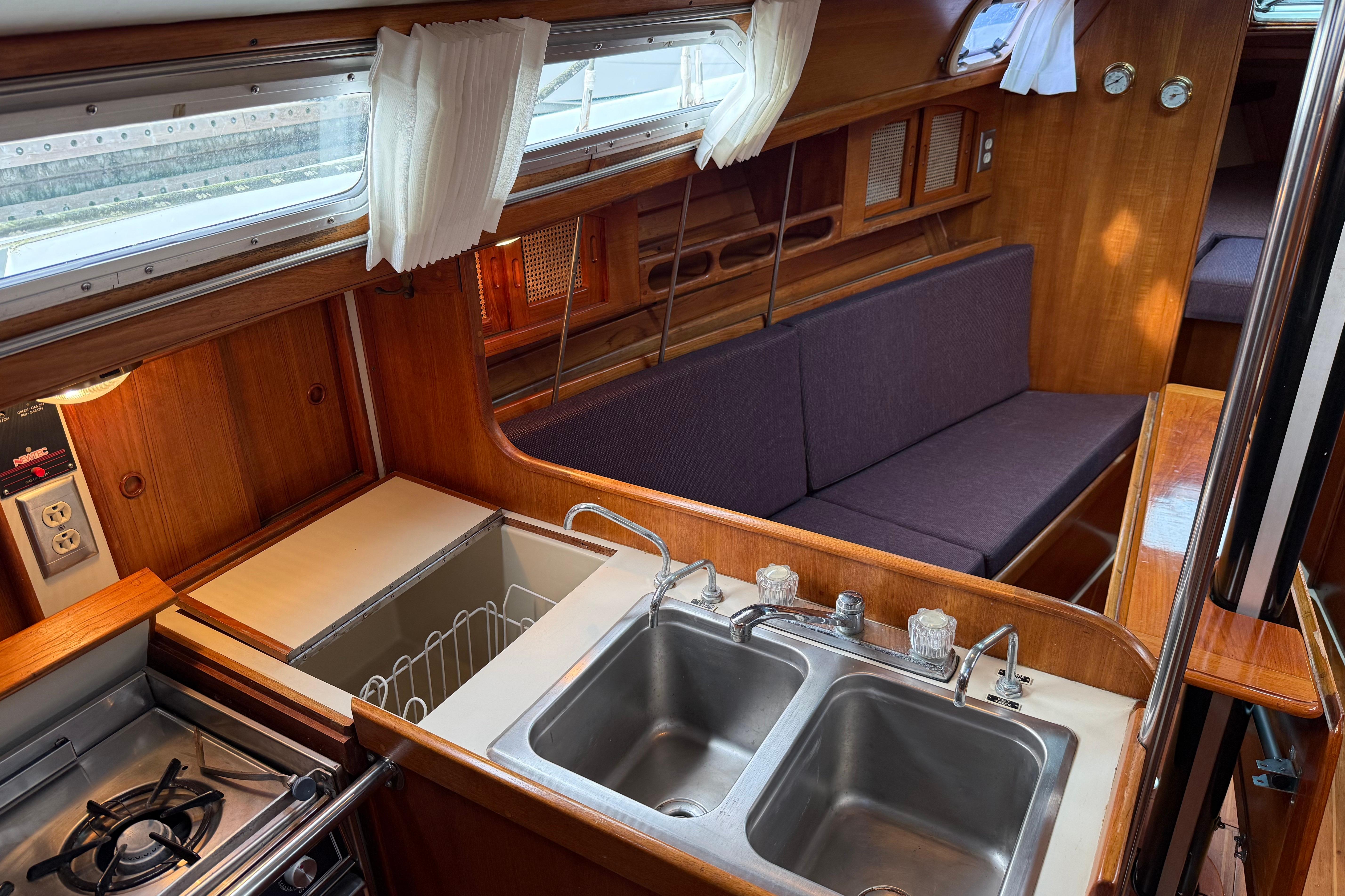 Interior of 1988 Ericson 32-200 sailboat with kitchen and seating area.
