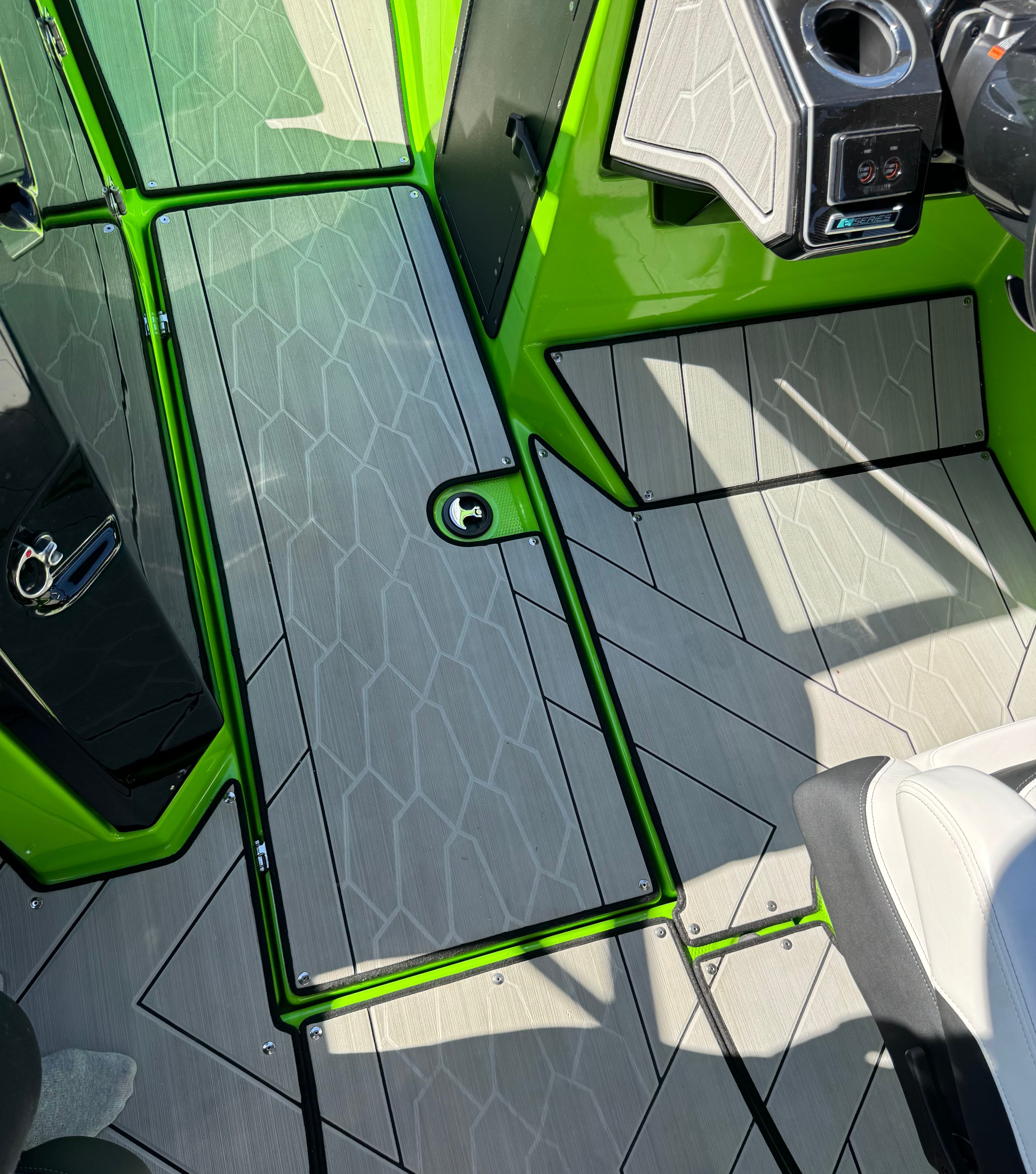 Green flooring on a 2022 Yamaha 255XD boat, featuring modern patterns and details.