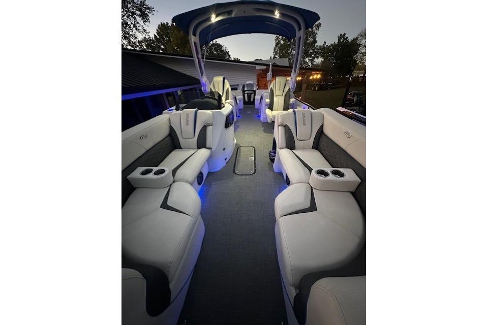 Luxurious interior of a 2020 Manitou 25 X-Plode RFW pontoon boat with ambient lighting.