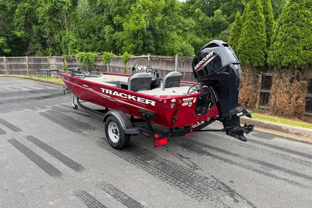 2022 Tracker Pro 170 boat with Mercury engine on trailer, parked outdoors.