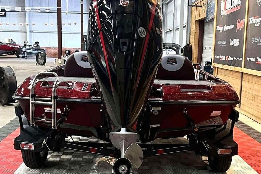 2026 Ranger Z185 boat in showroom, rear view with powerful outboard motor.