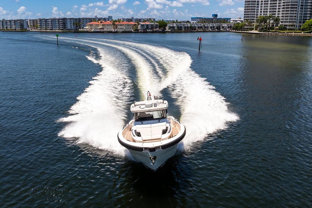 2021 Bluegame BG 42 yacht cruising on a sunny day in a coastal waterway.