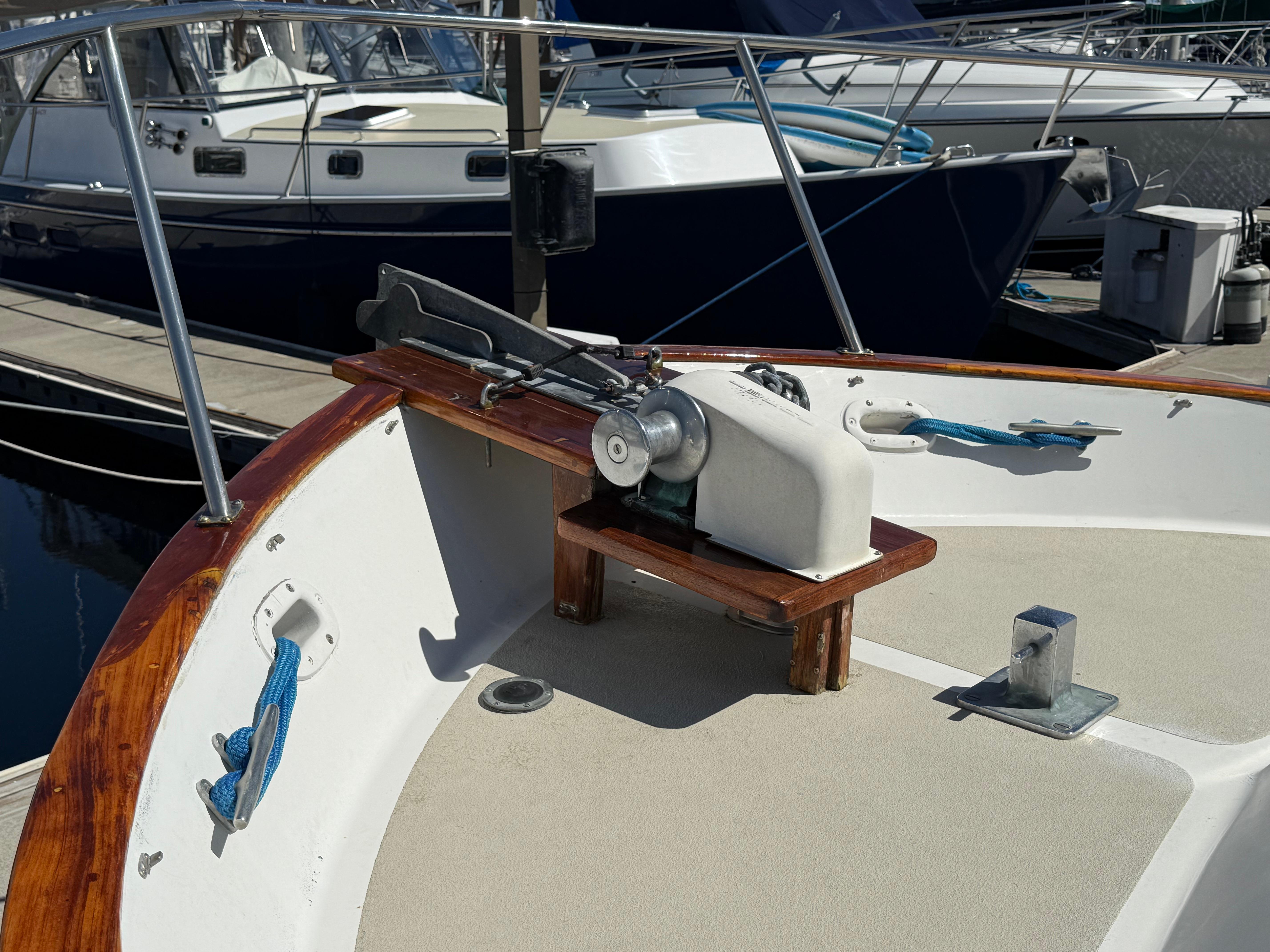 1983 Californian 34 boat deck with anchor winch and mooring lines at marina.