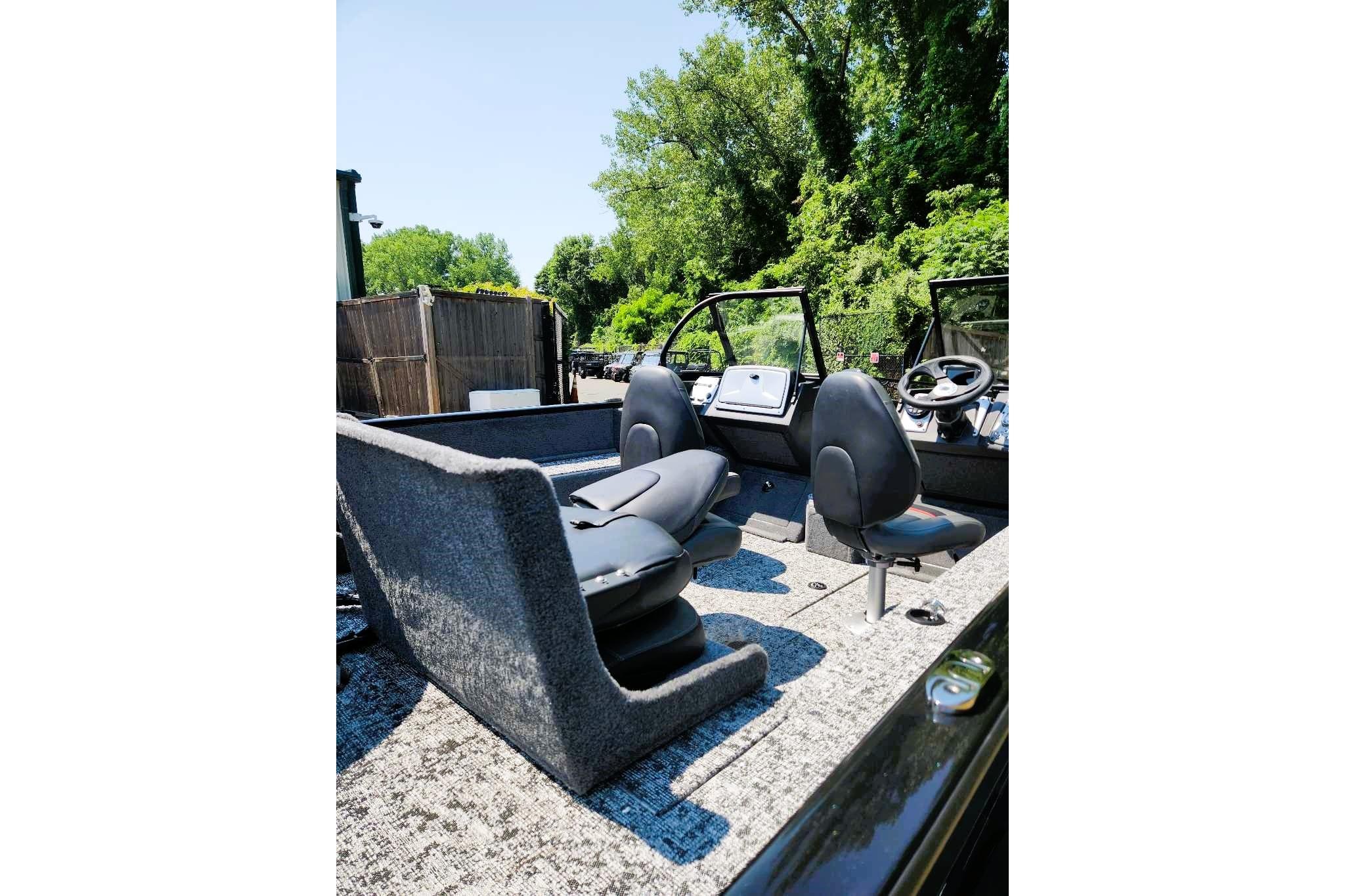 2026 Tracker Pro Guide V-175 Combo boat interior with seating and steering wheel.