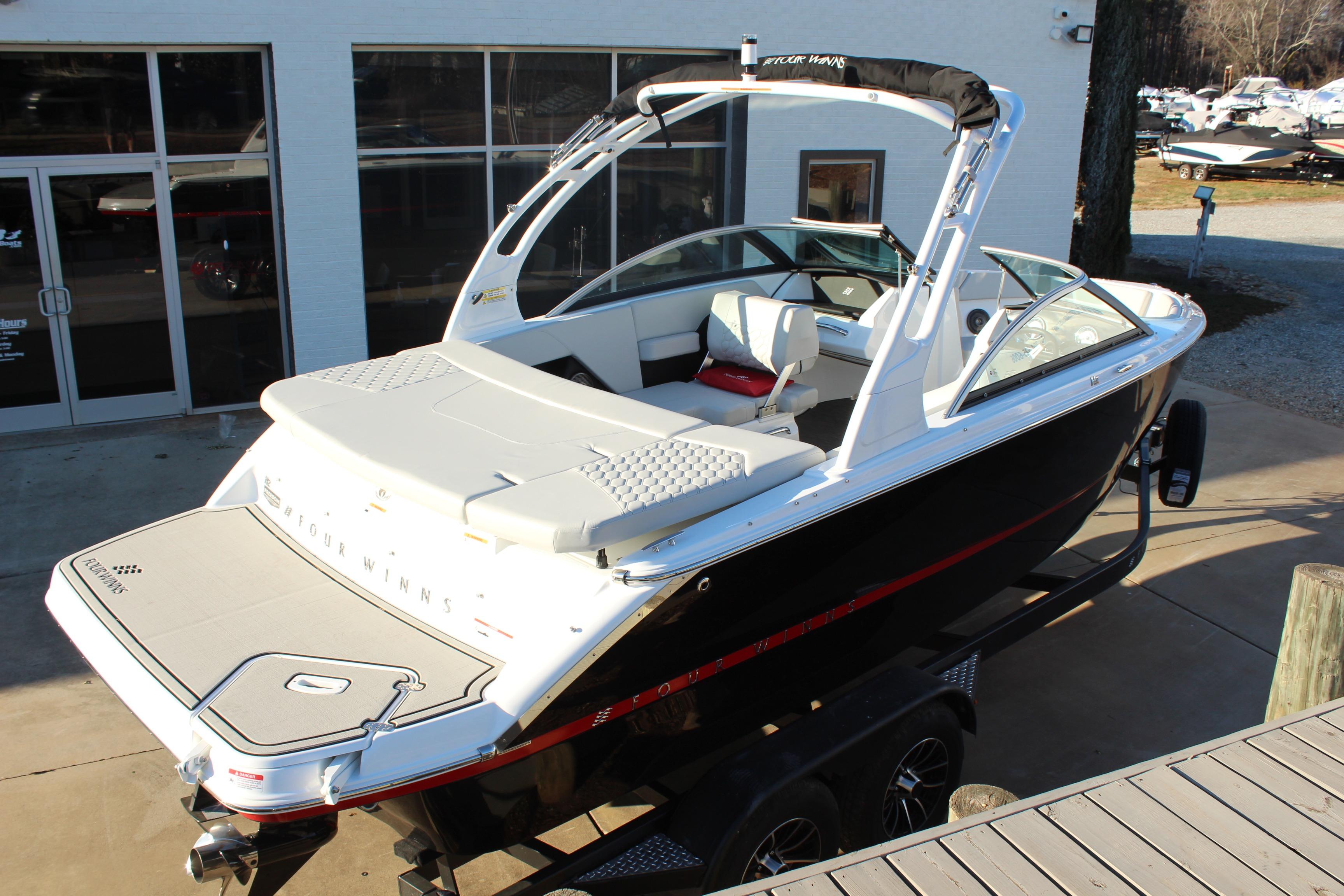 2026 Four Winns H2 Freedom boat on trailer, sleek design, white and black exterior.
