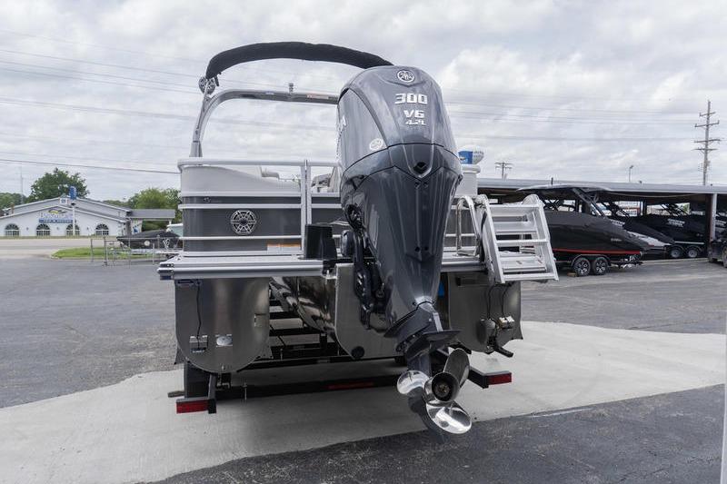 2026 SunCatcher Elite 326 SS pontoon boat with powerful 300 V6 engine, parked outdoors.