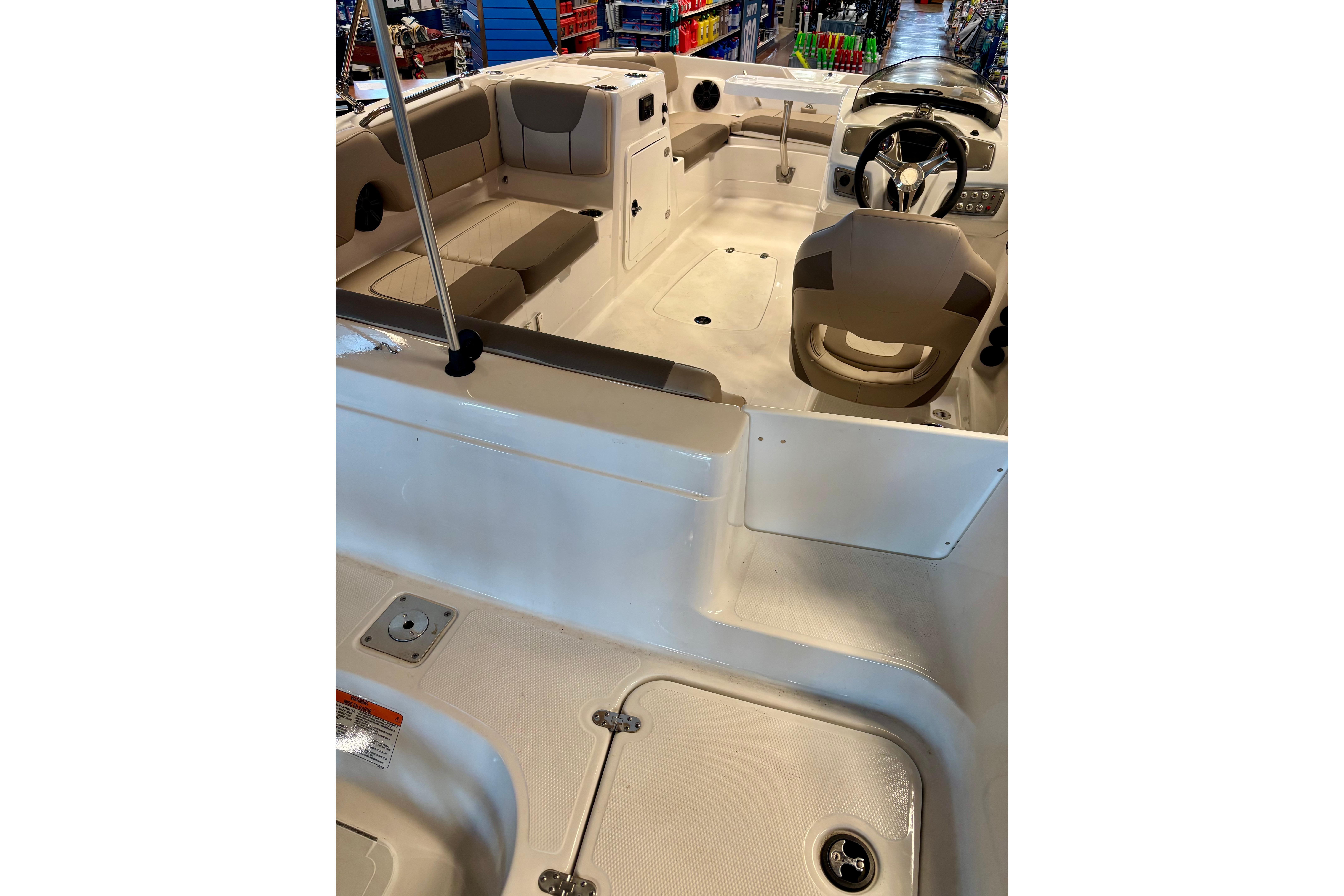 2026 Tahoe 2150 boat interior with seating and steering wheel, showcasing modern design.