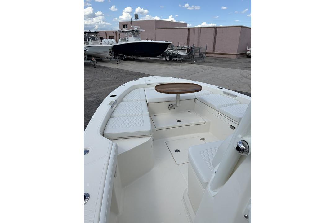 2026 Pathfinder 2800 Hybrid boat interior with cushioned seating and wooden table.