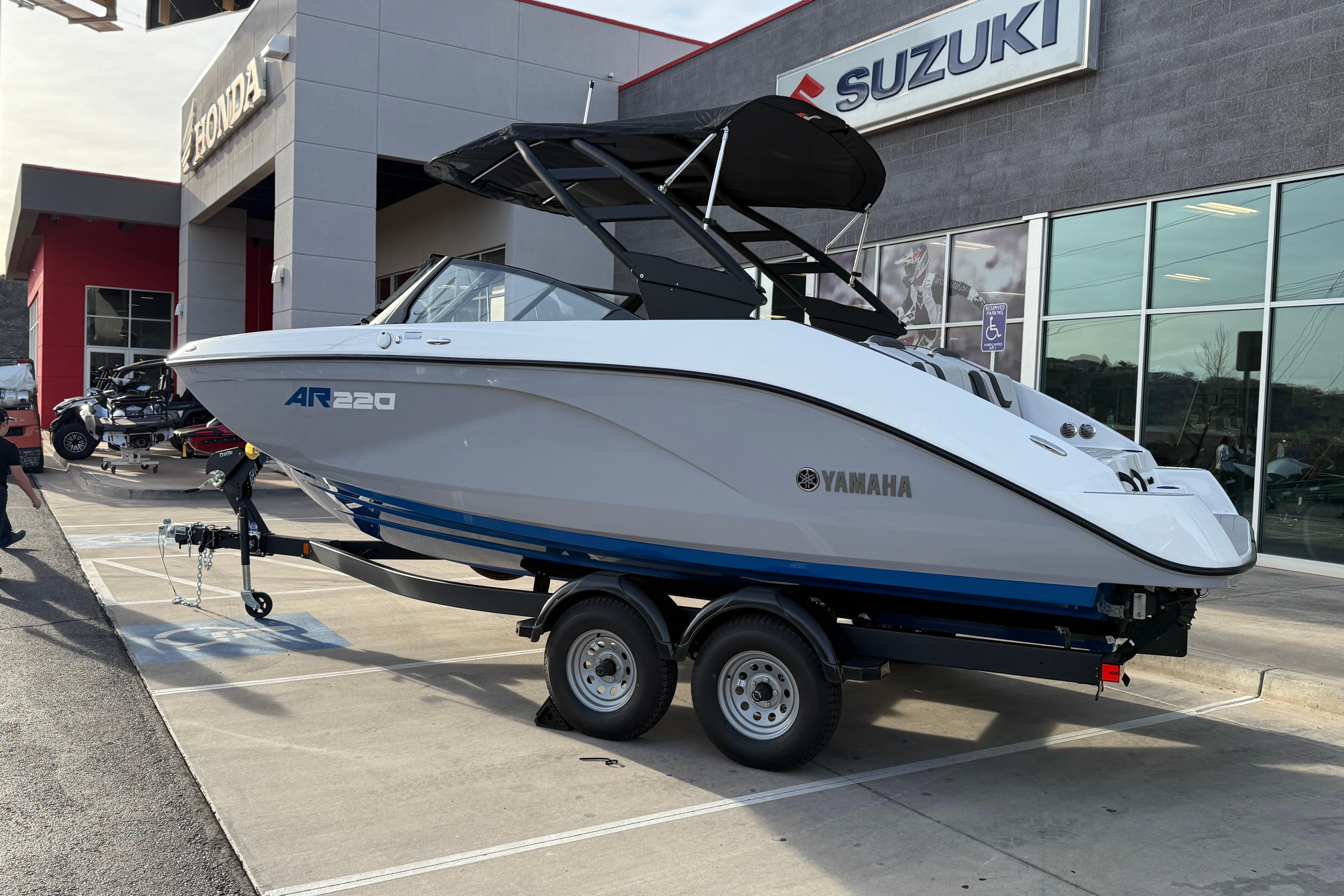 2026 Yamaha Boats AR220 on trailer outside dealership, showcasing sleek design and modern features.