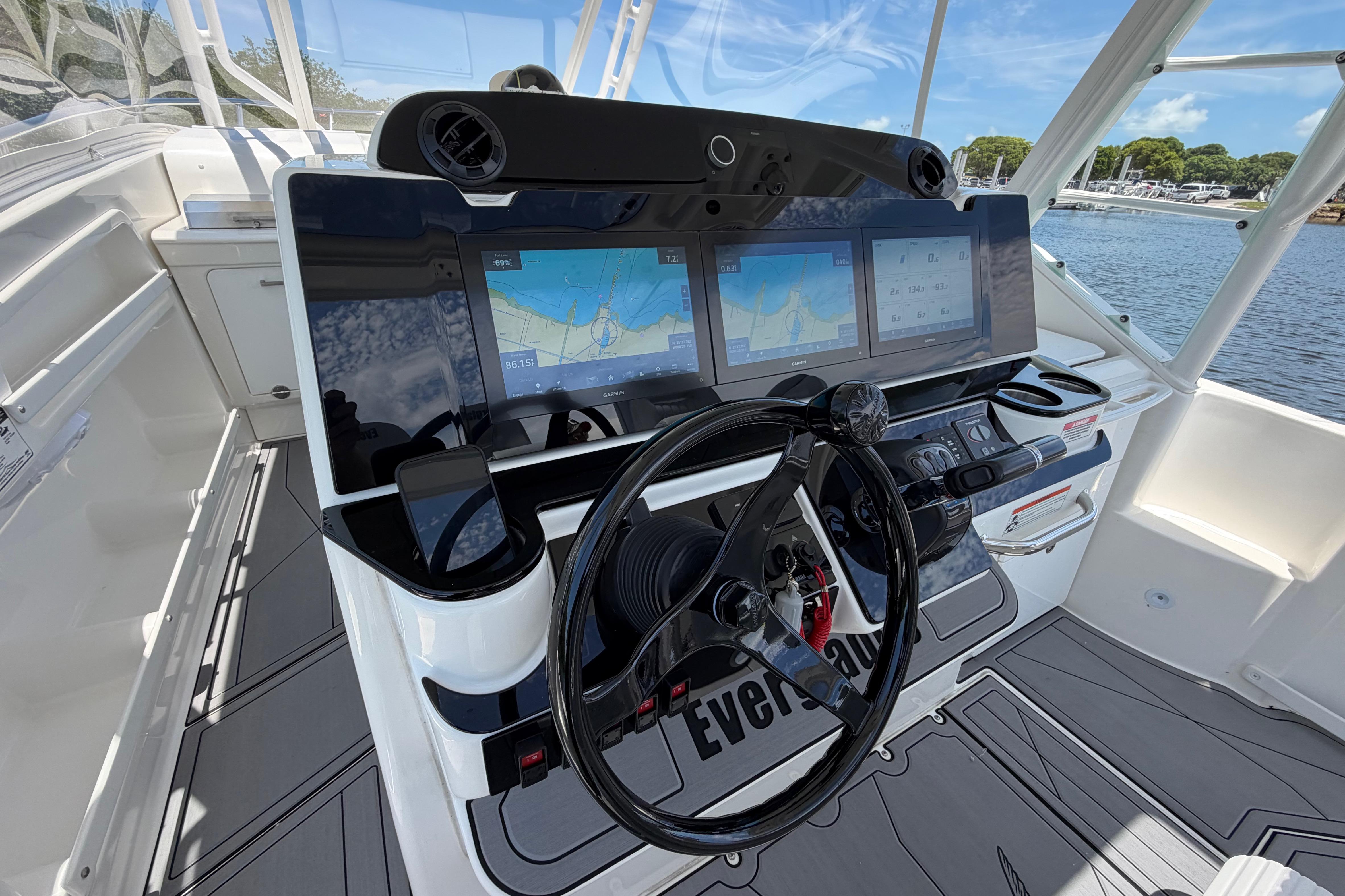 Cockpit of 2009 Everglades 350LX boat with advanced navigation displays and steering wheel.