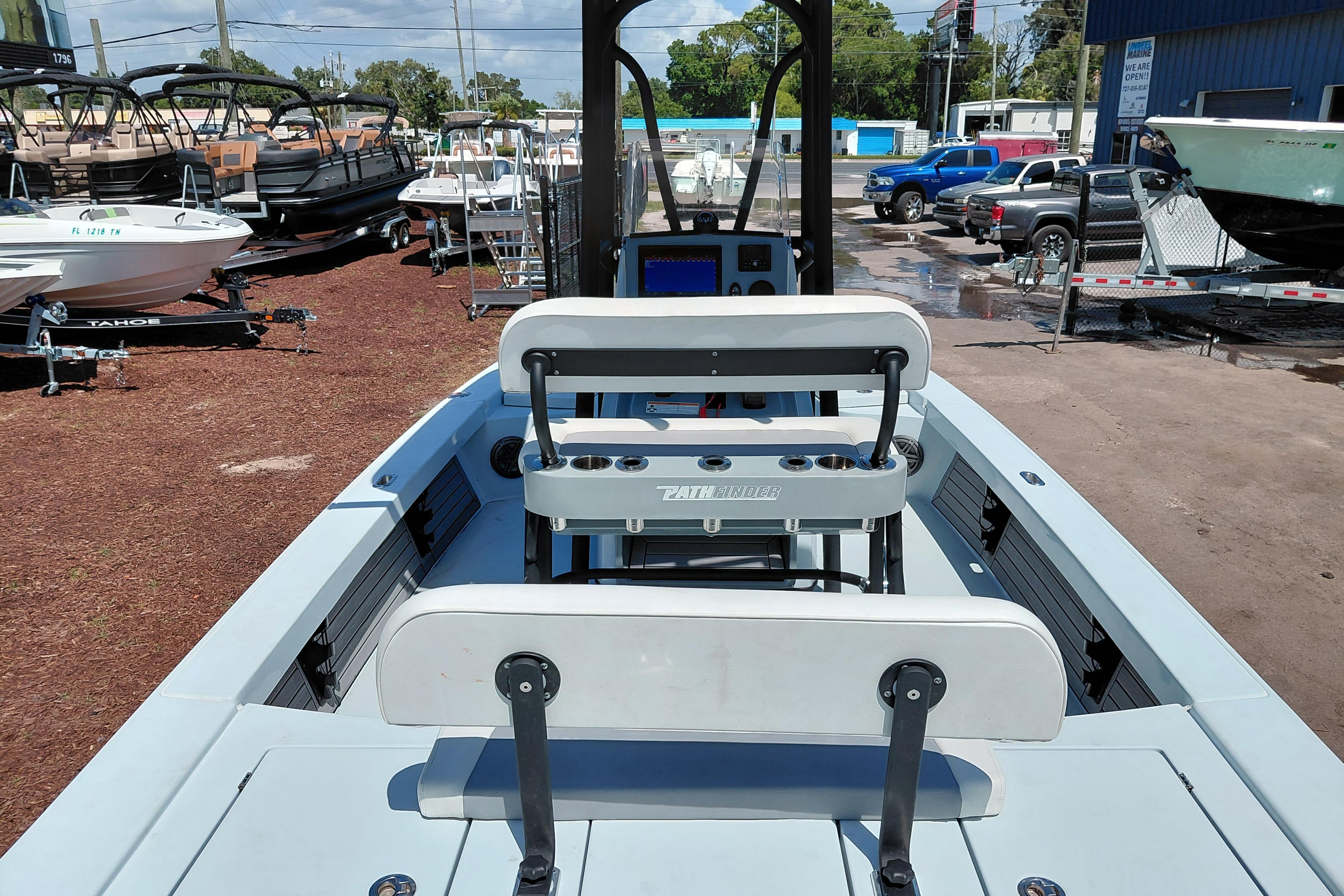 2022 Pathfinder 2300 HPS boat interior with seating and console, displayed outdoors.