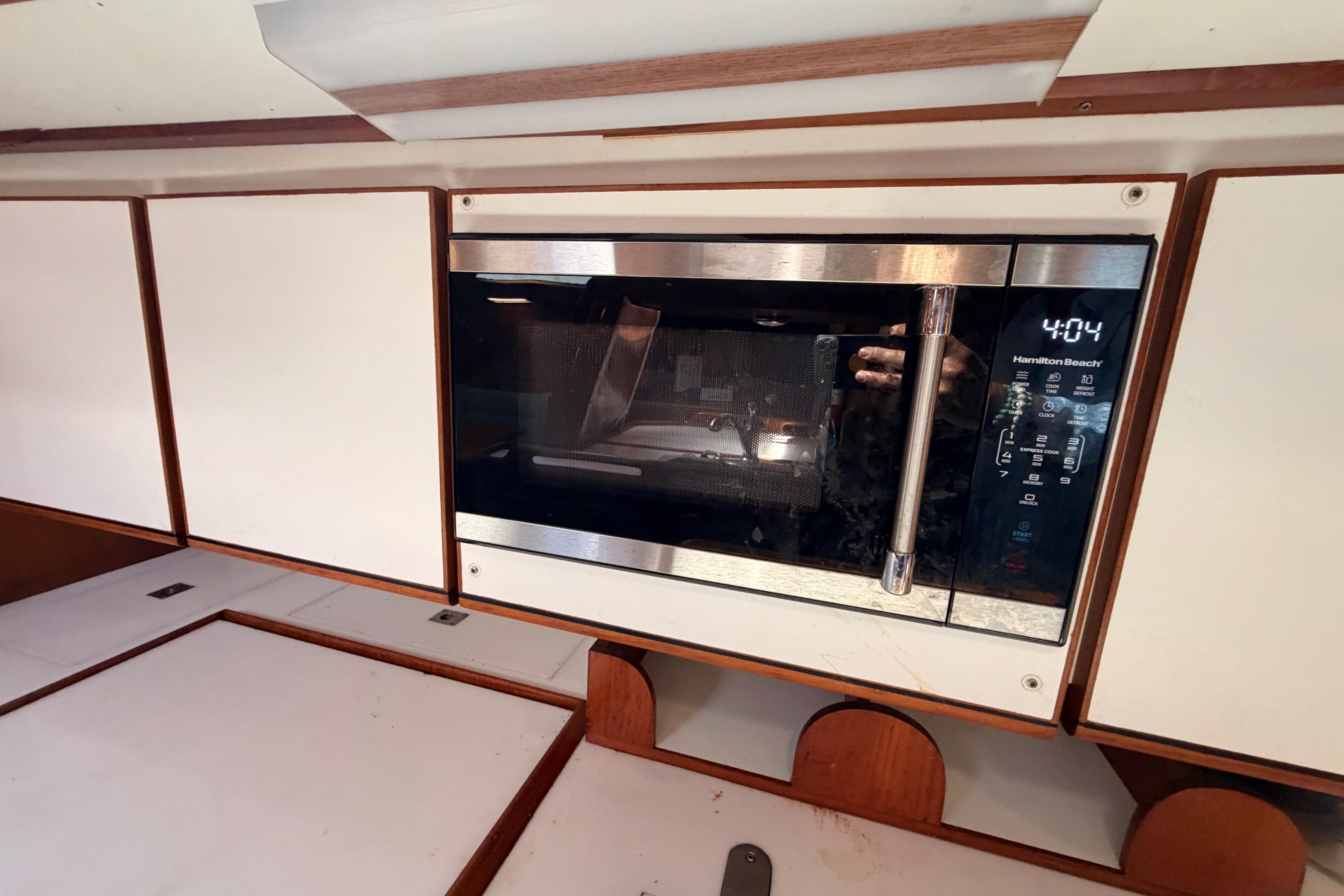 Built-in microwave in a 1991 Hylas 51 yacht kitchen interior.