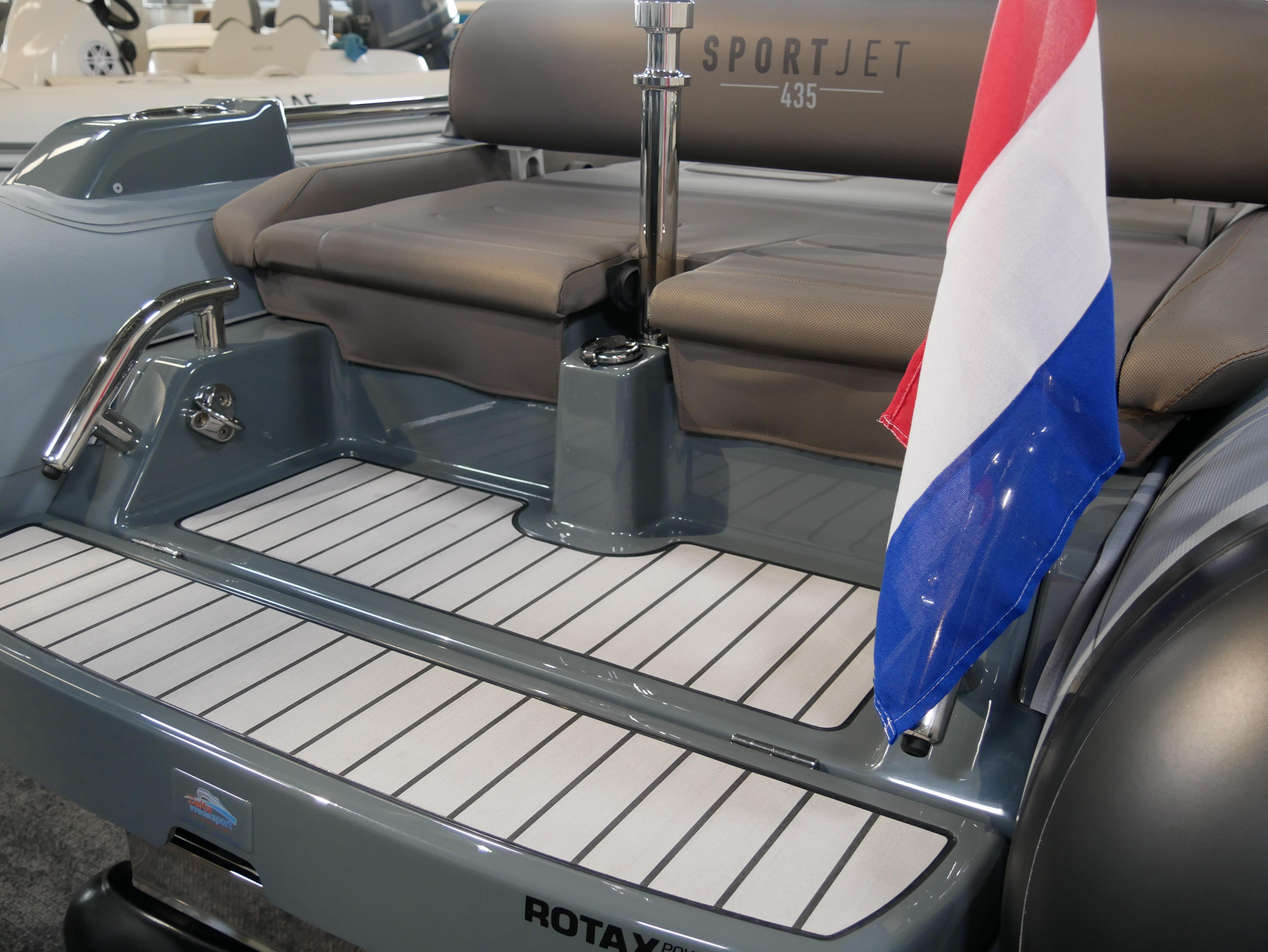 2025 Williams Jet Tenders SportJet 435 with flag, showcasing sleek seating and deck design.
