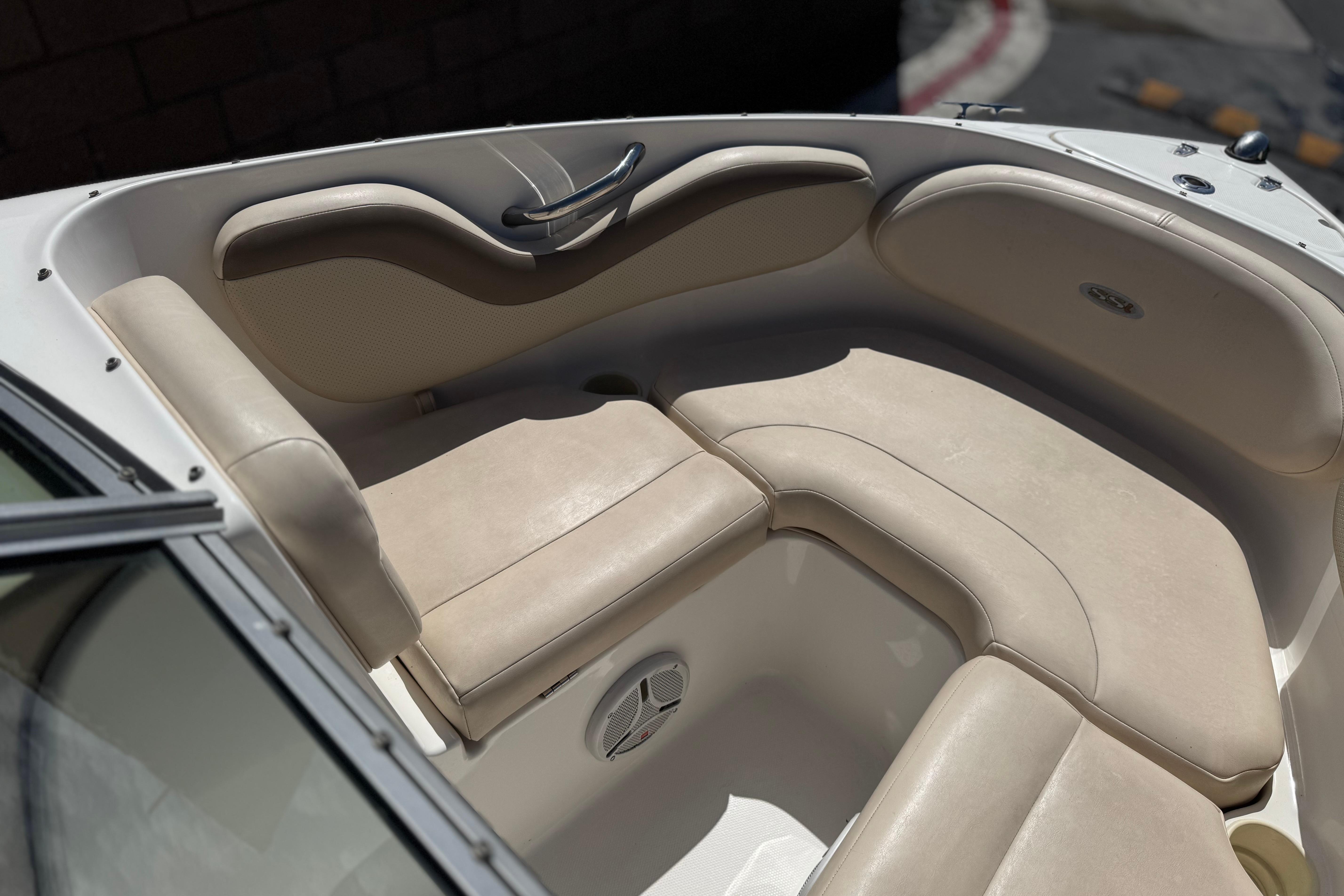 2006 Chaparral 190 SSi boat interior with beige seating and stainless steel handle.