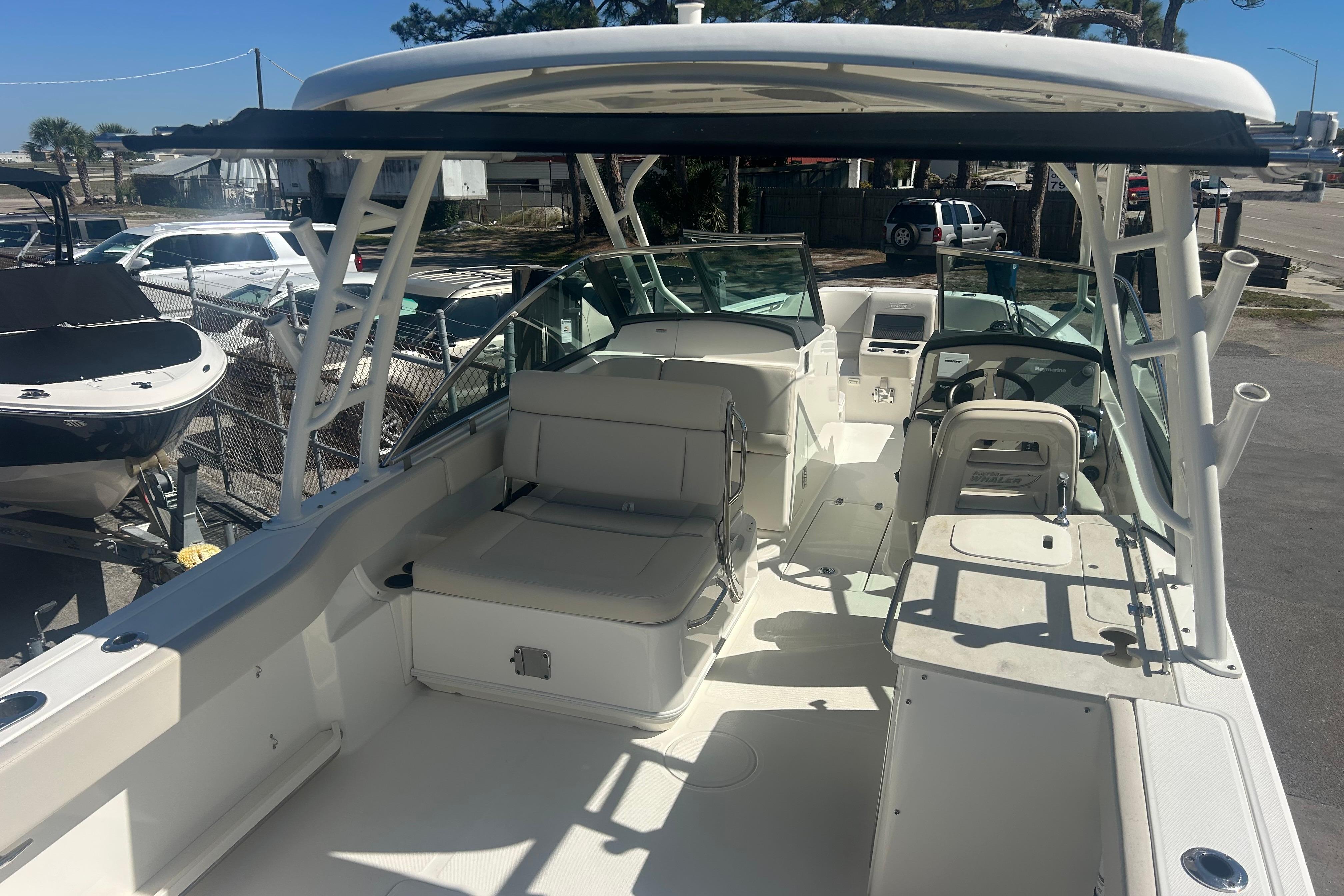 2018 Boston Whaler 270 Vantage boat interior with seating and helm, docked outdoors.