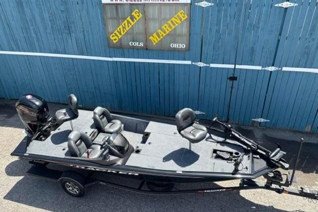 2023 Tracker Pro Team 190 TX Tournament Edition fishing boat, parked near blue wall.