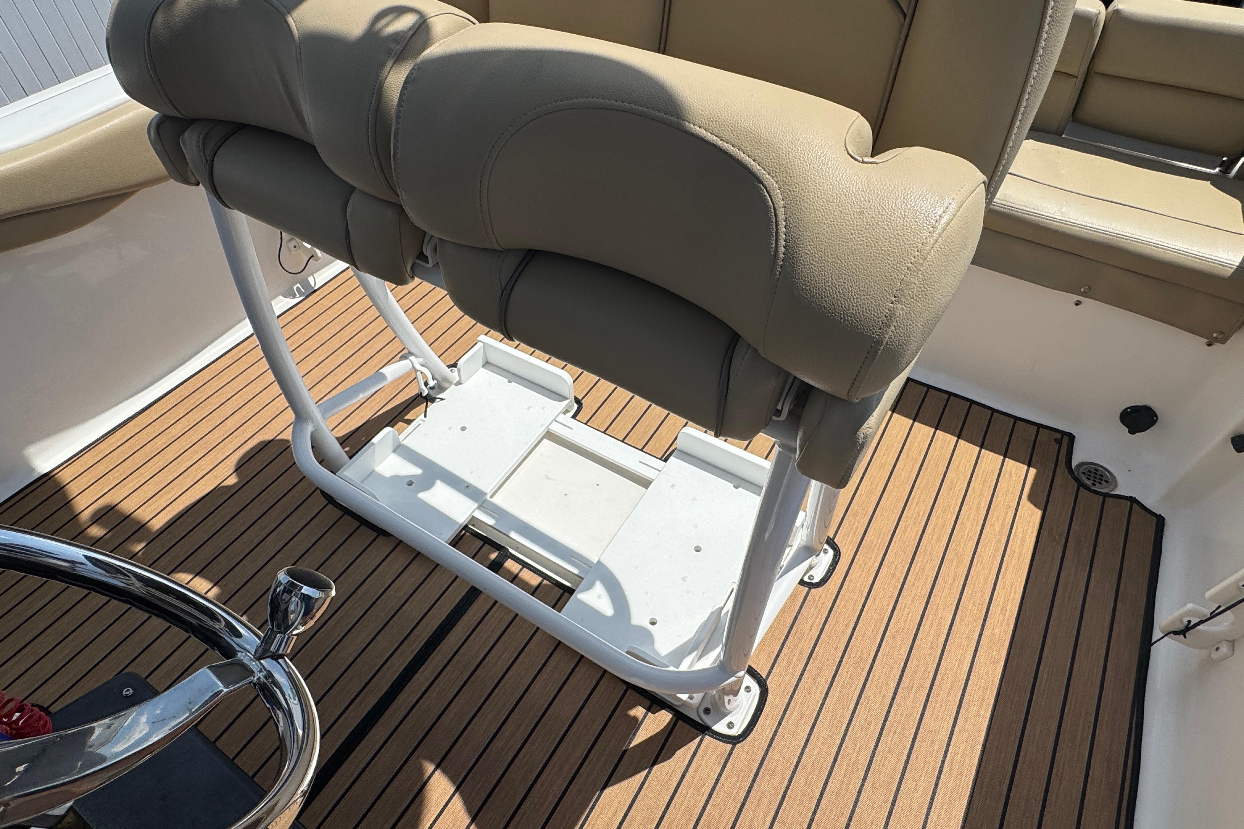 2016 Tidewater 230 LXF boat interior with tan seating and wood-patterned flooring.