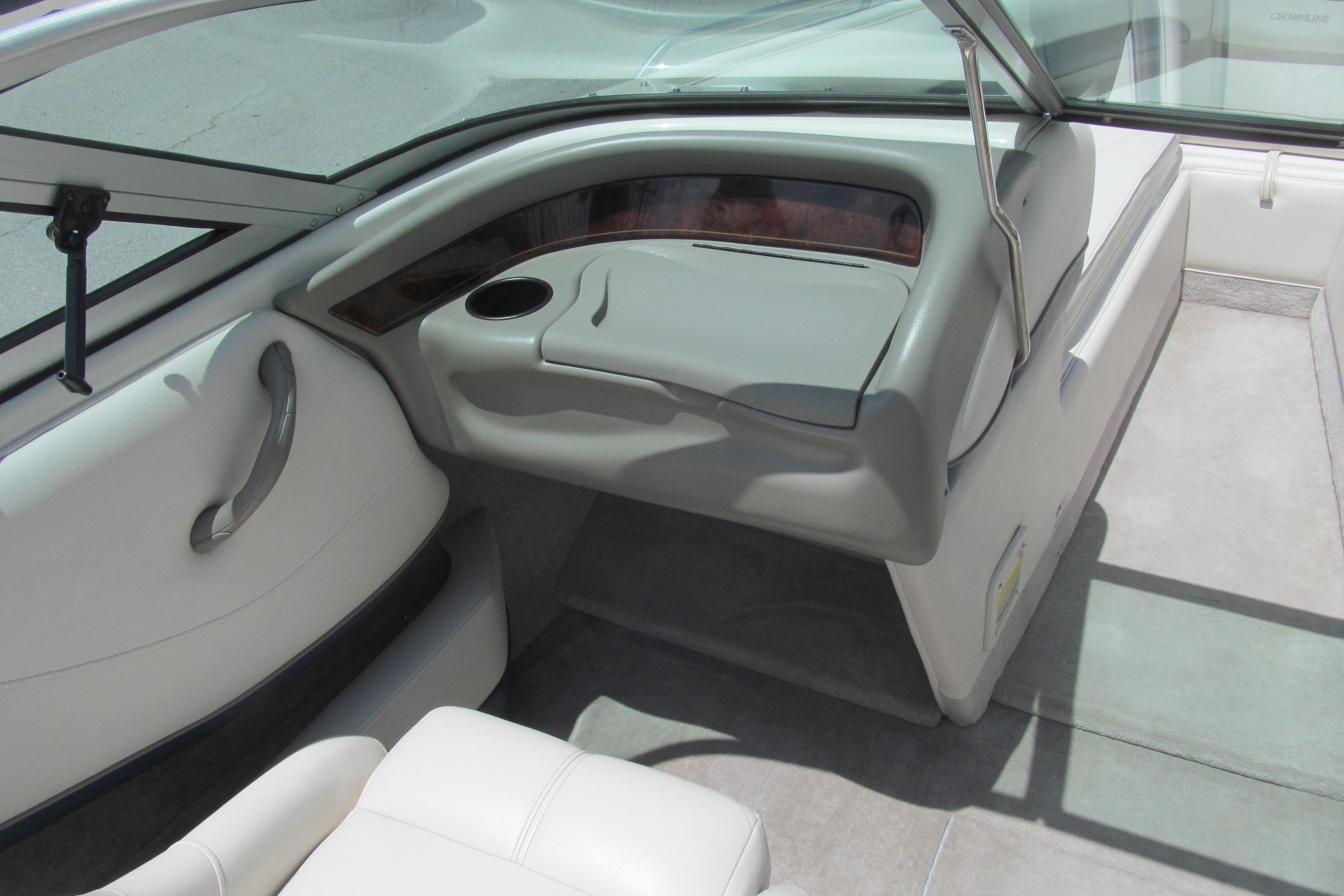 Interior of a 2001 Crownline 225 BR boat, featuring sleek seating and dashboard design.