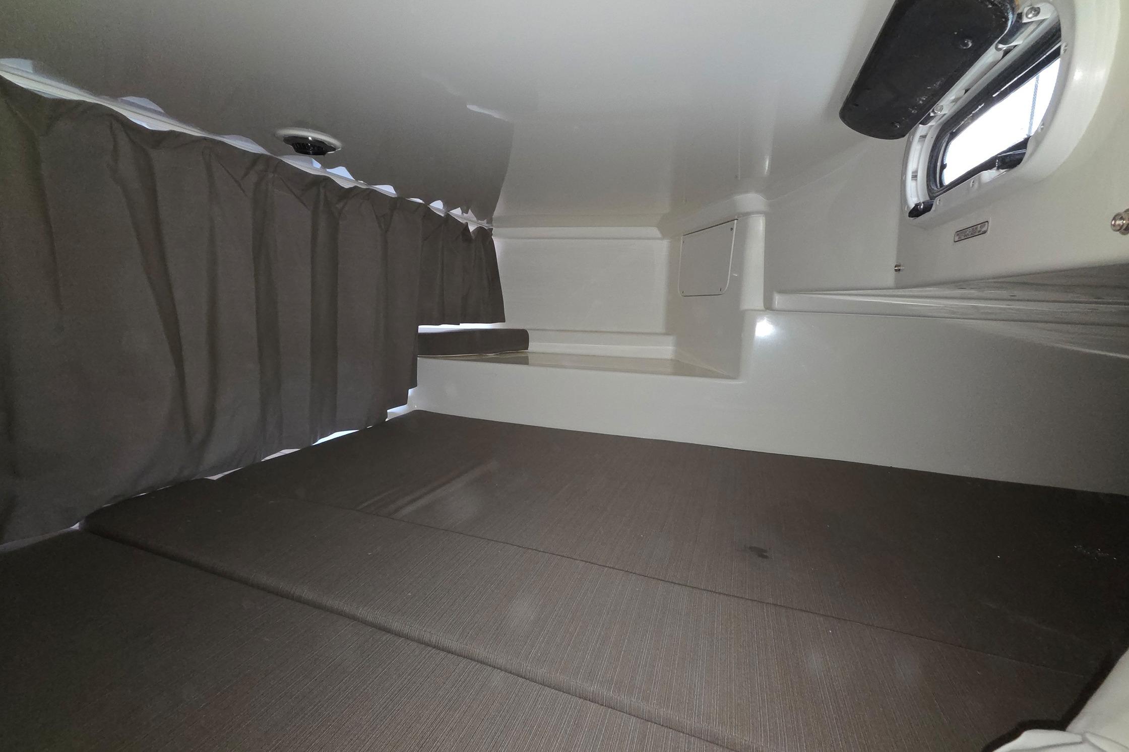 Interior cabin of 2017 Quicksilver Activ 805 Cruiser with curtains and window.