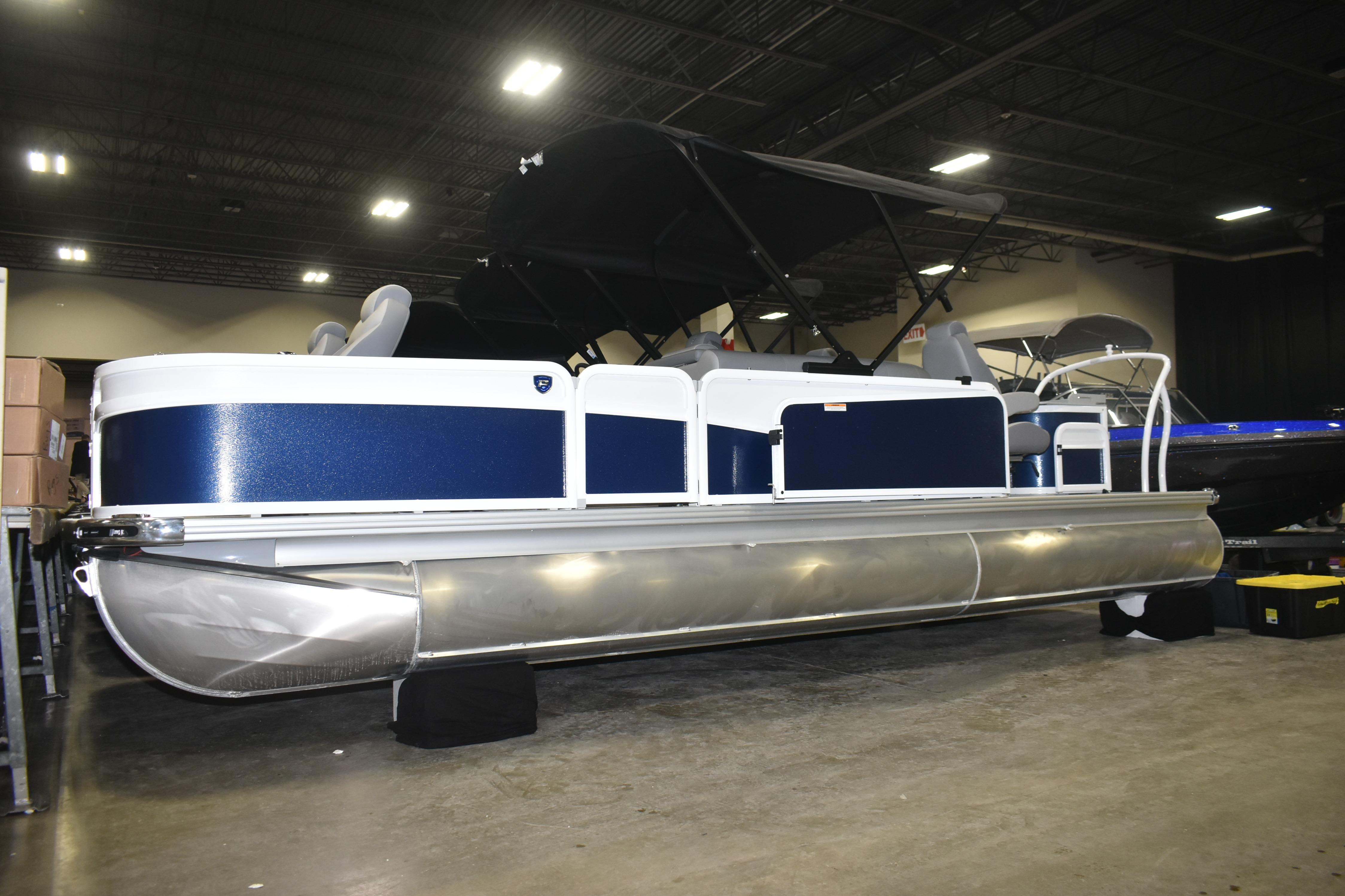 2026 Premier 230 Sunsation Angler 4PT PTX pontoon boat displayed indoors.