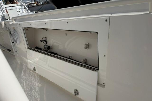 2014 Edgewater 318CC boat storage compartment with open hatch, showcasing interior details.