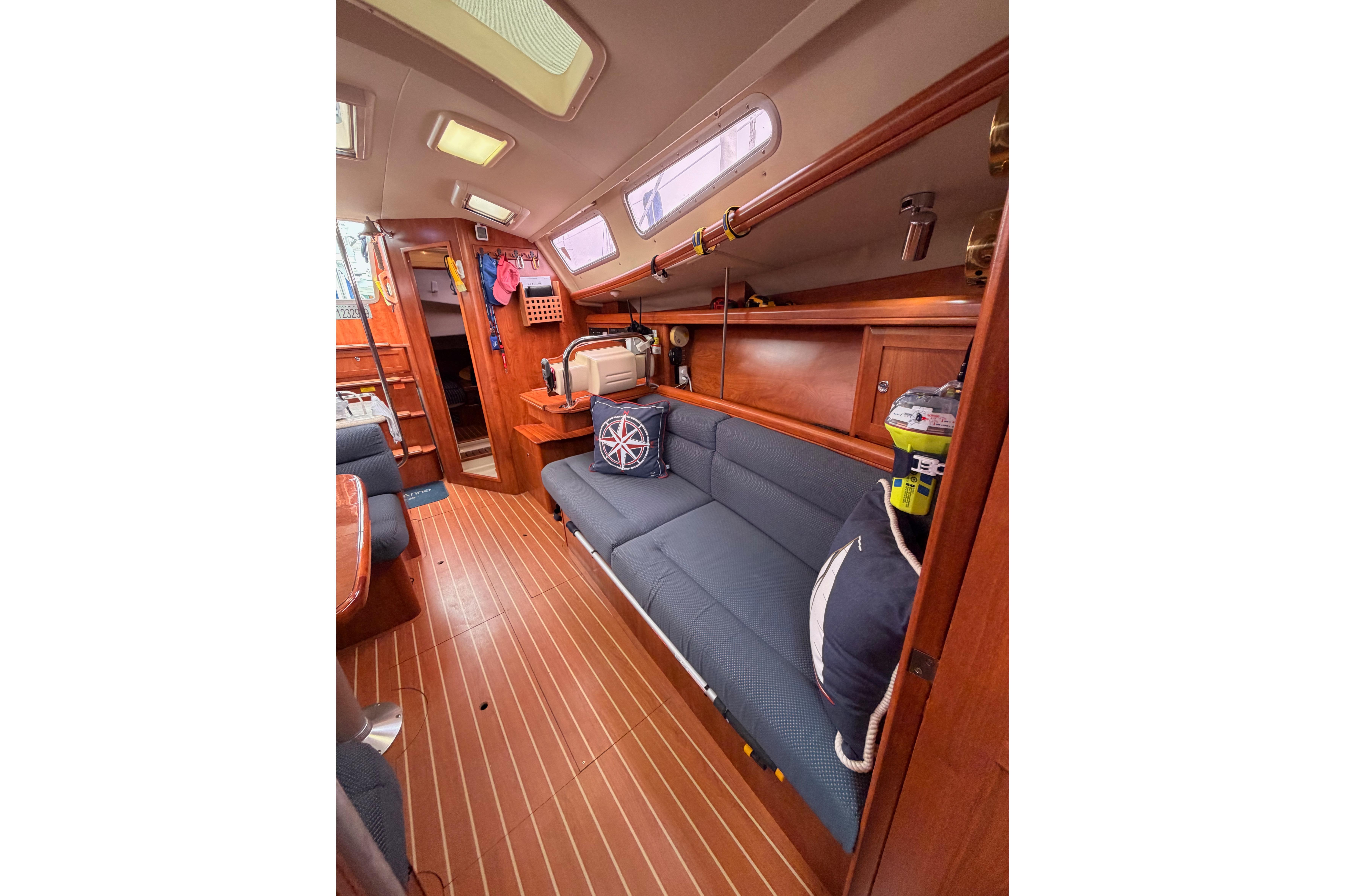 2009 Hunter 38 yacht interior with wooden flooring and blue seating.