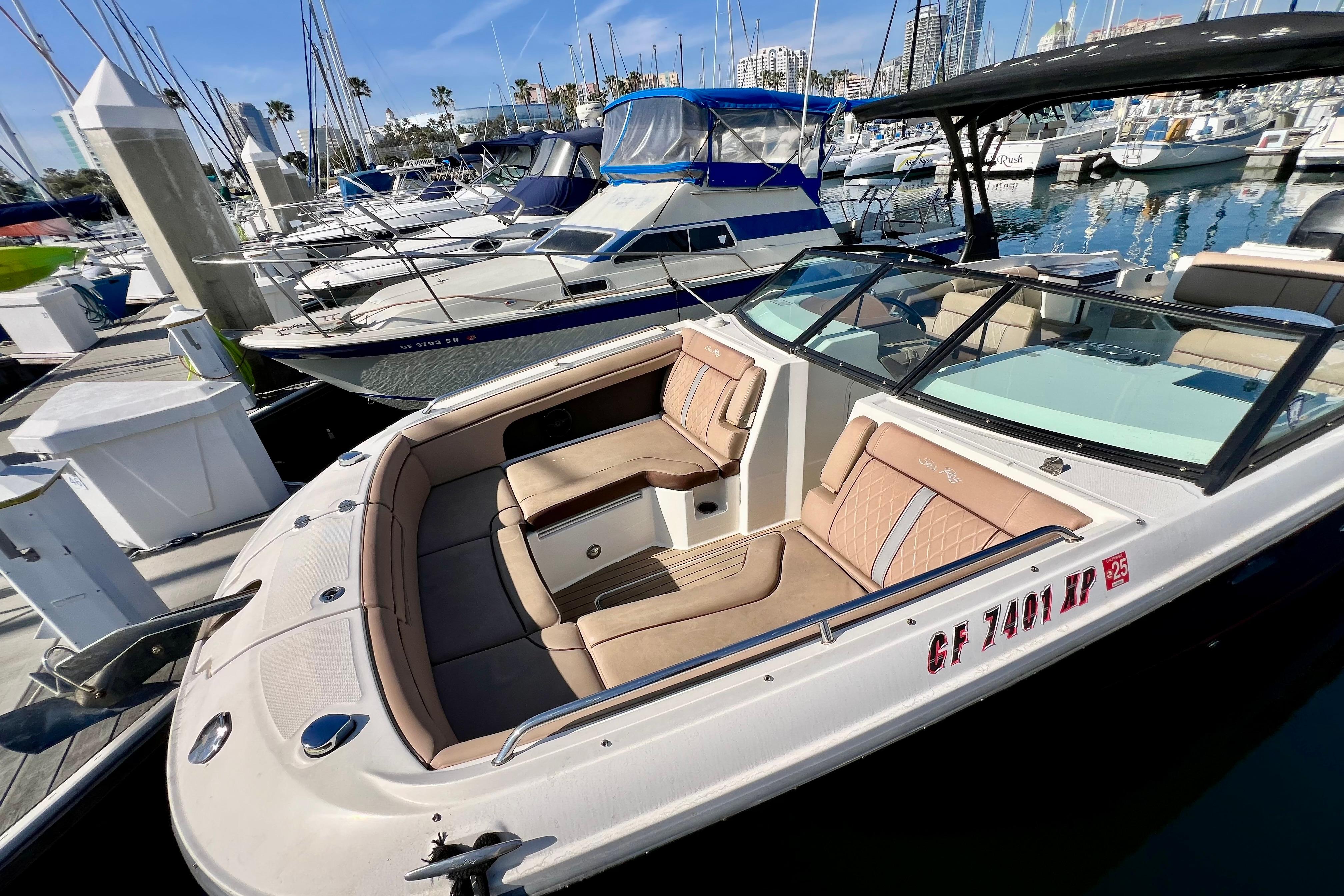 2016 Sea Ray 290 Sundeck Outboard docked in a marina, showcasing luxurious seating.