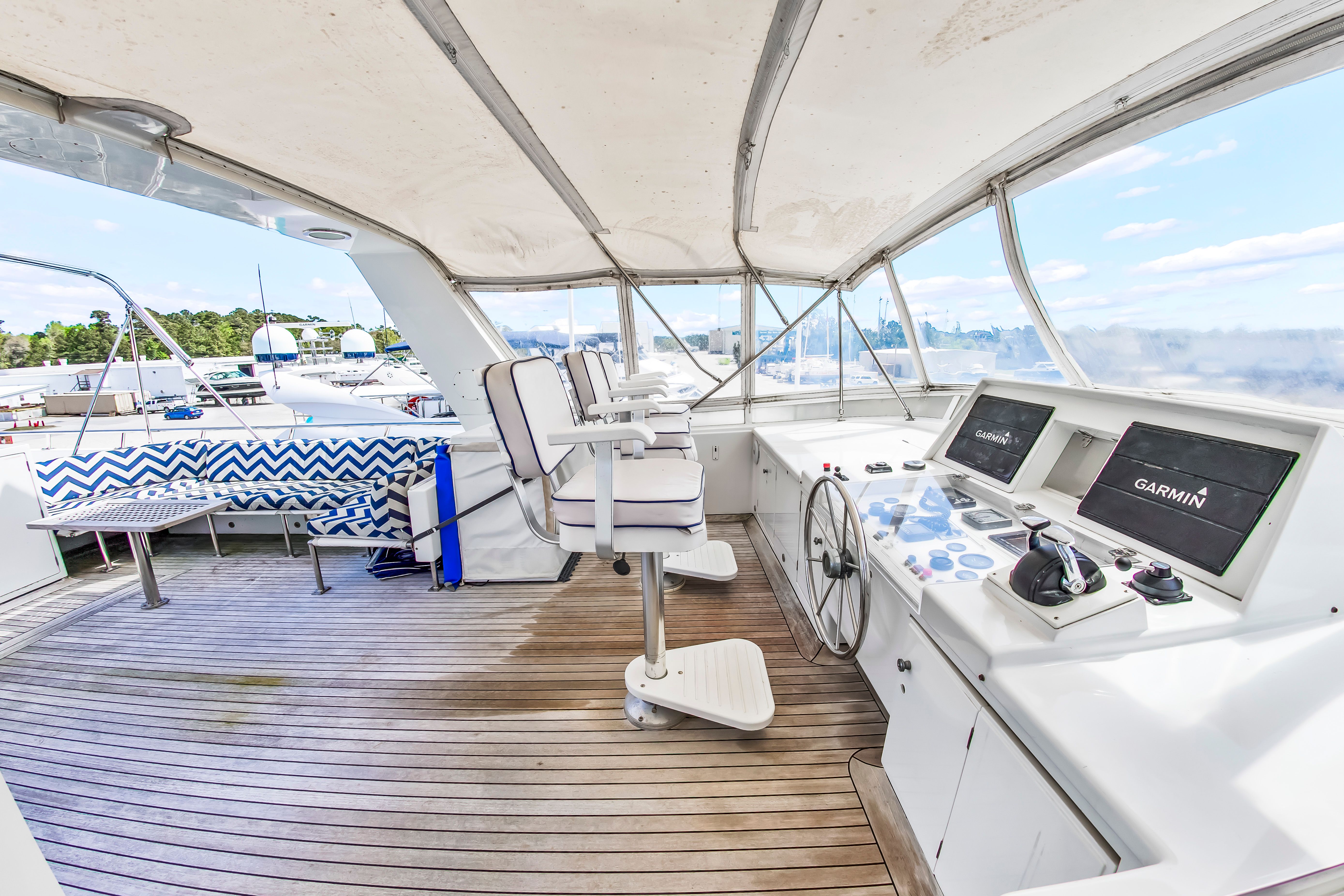 The image shows the helm of a 1987 Jongert 78 Motor Yacht with modern navigation systems.