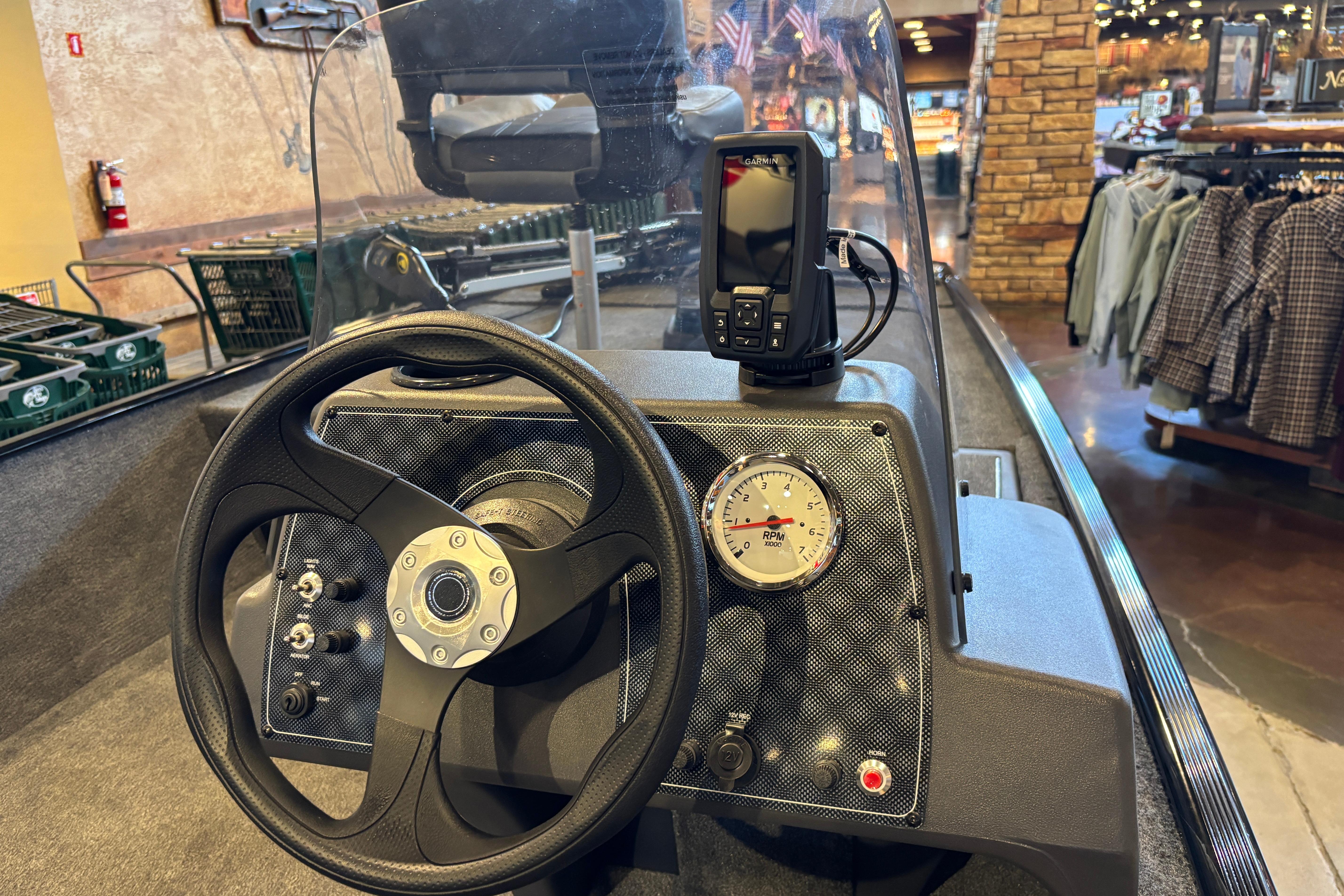 2026 Tracker Bass Tracker Classic XL boat dashboard with steering wheel and navigation display.