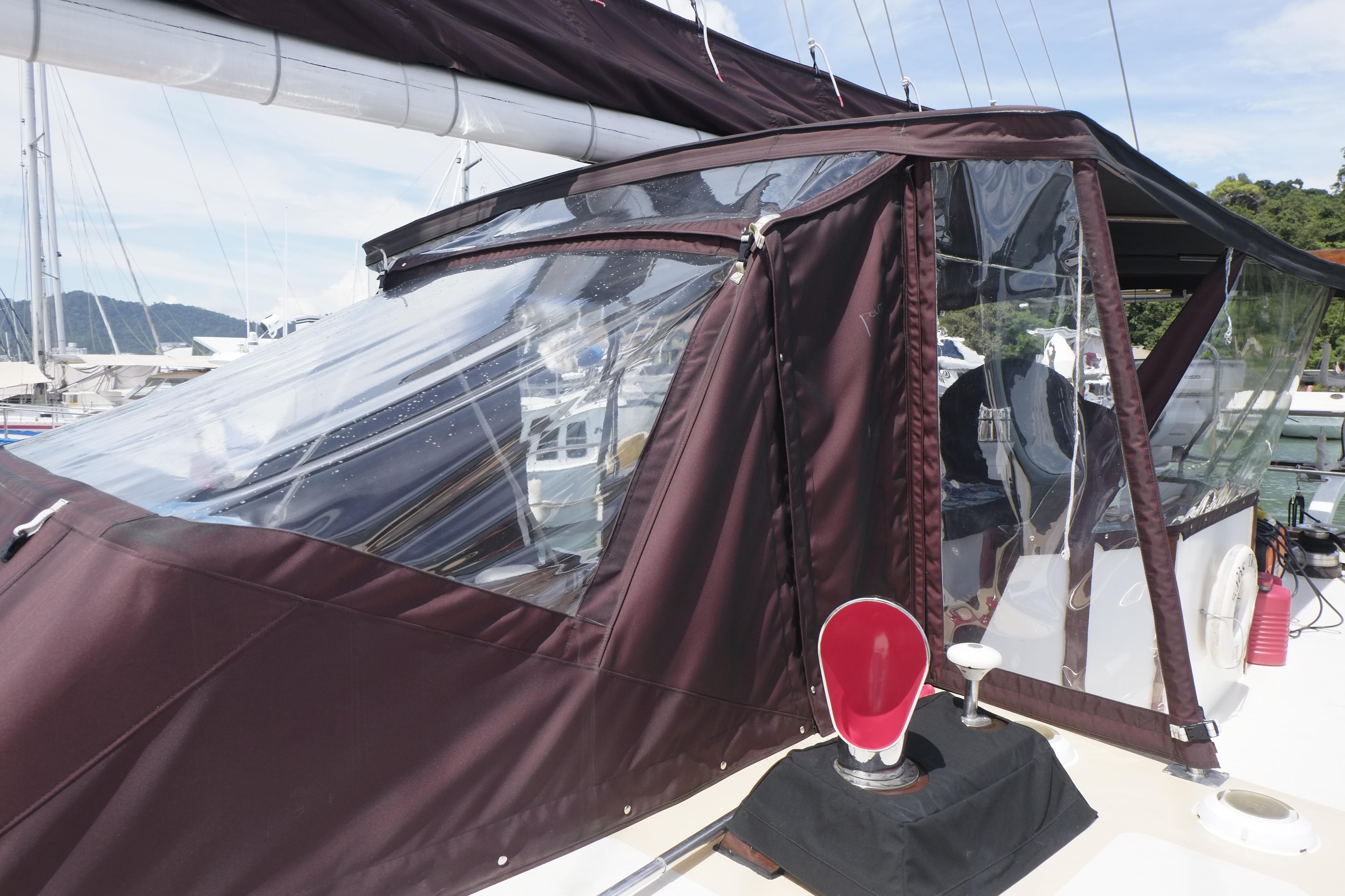 Custom Bud Macintosh schooner, 2006, with brown canopy and clear windows docked at marina.
