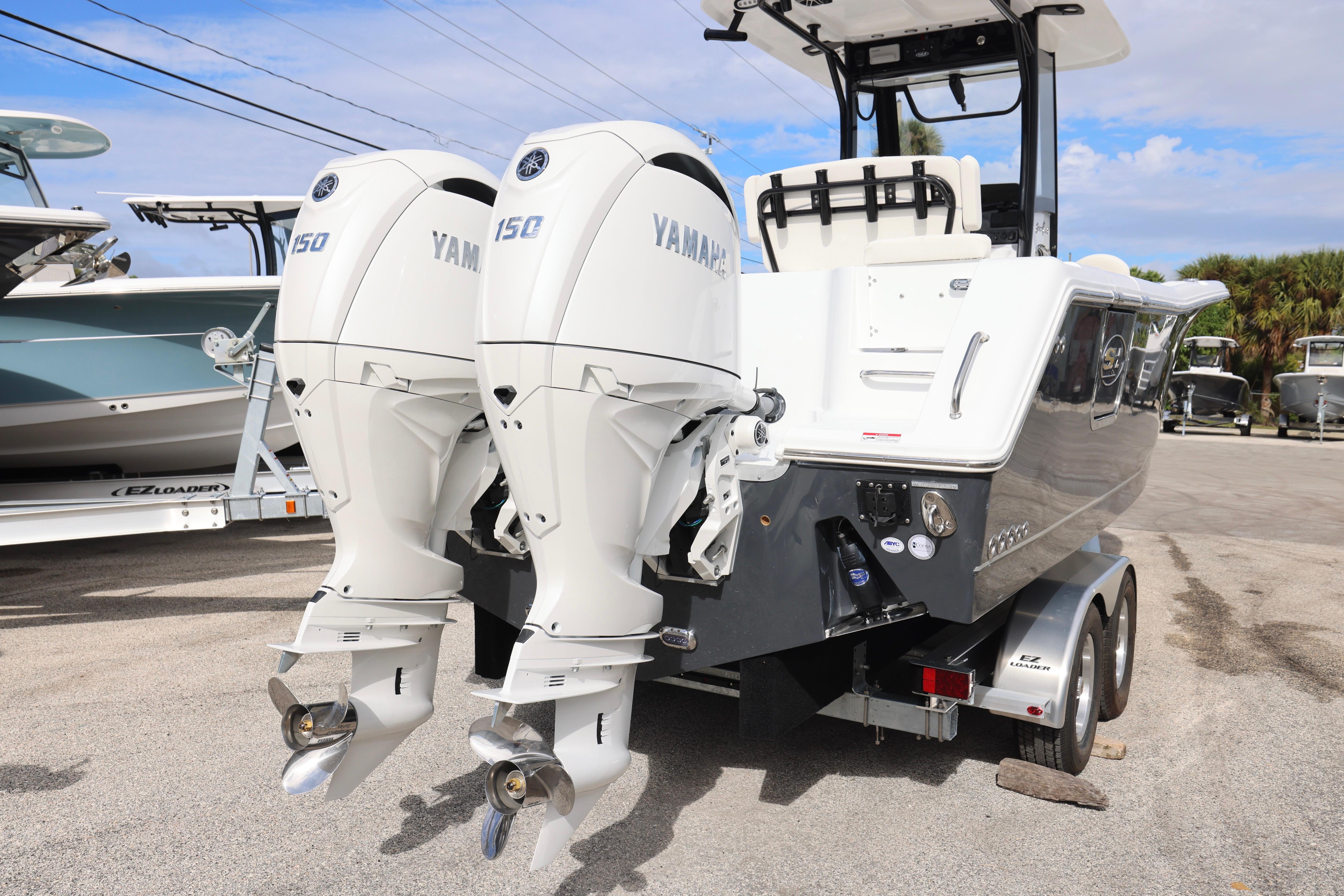 2026 Sea Hunt Gamefish 25 with dual Yamaha 150 engines on trailer.