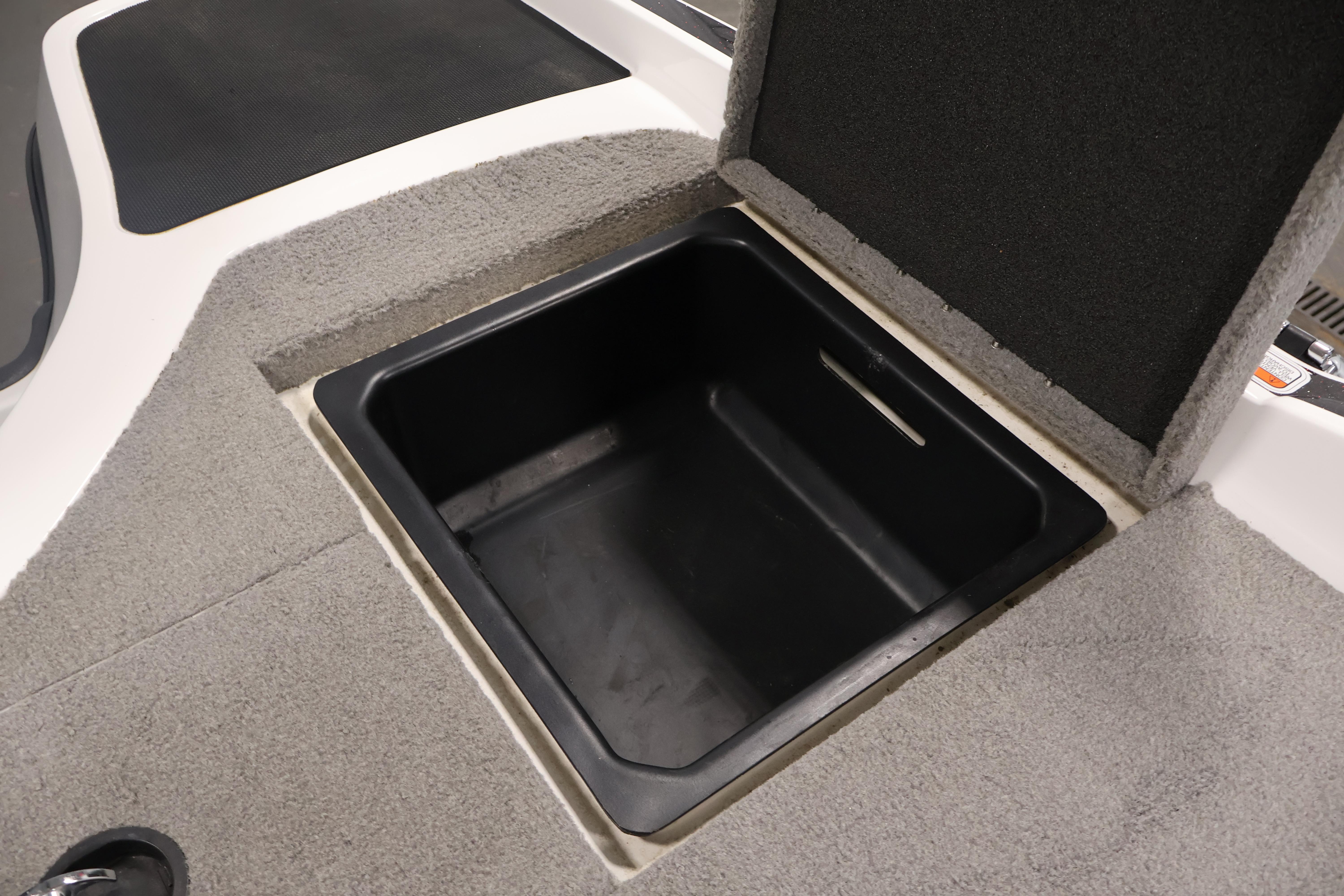 Open storage compartment in 2019 Nitro Z19 Sport boat, featuring carpeted interior.