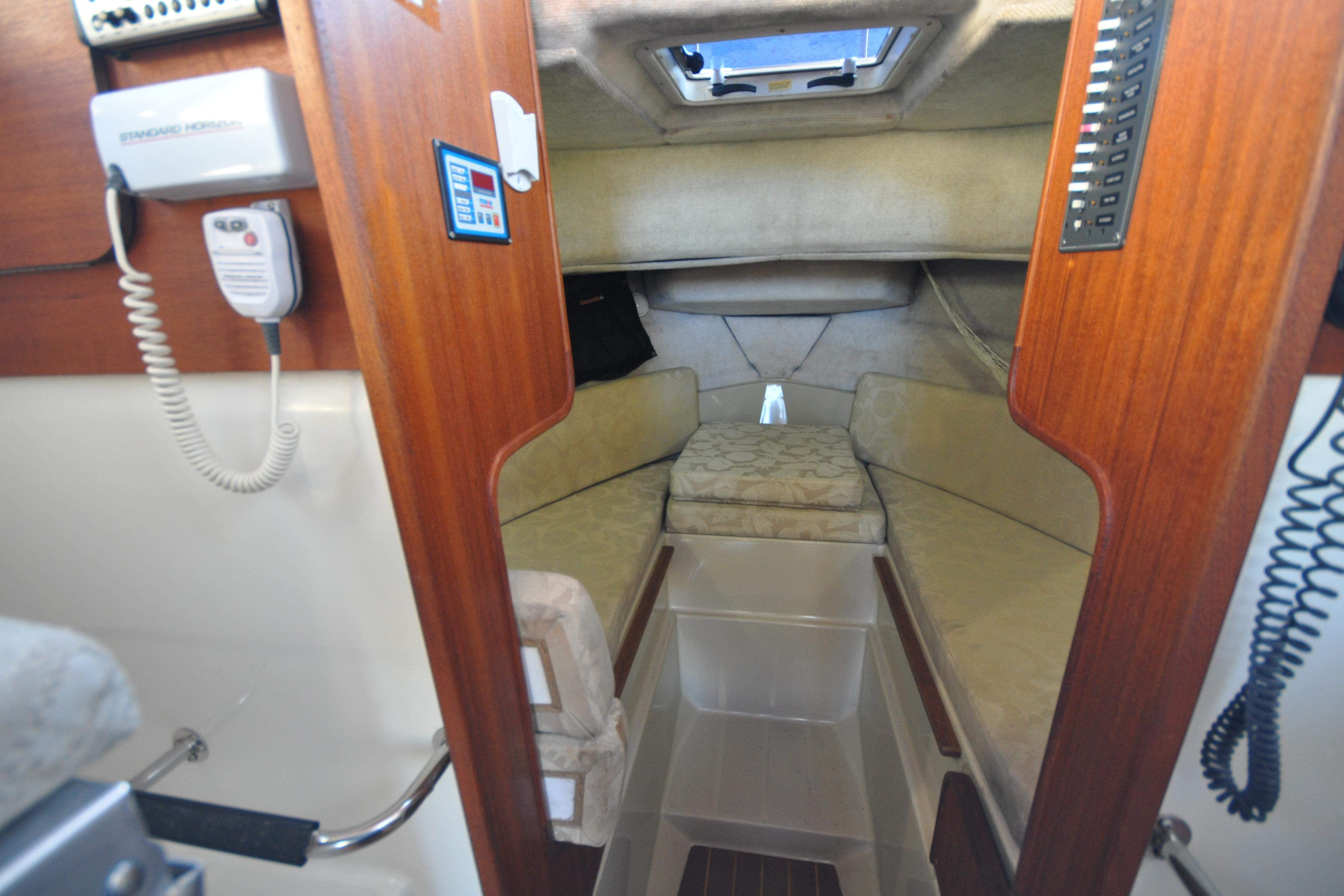 Interior cabin of 2007 Ranger Tug R-25 with cozy sleeping area and wooden accents.