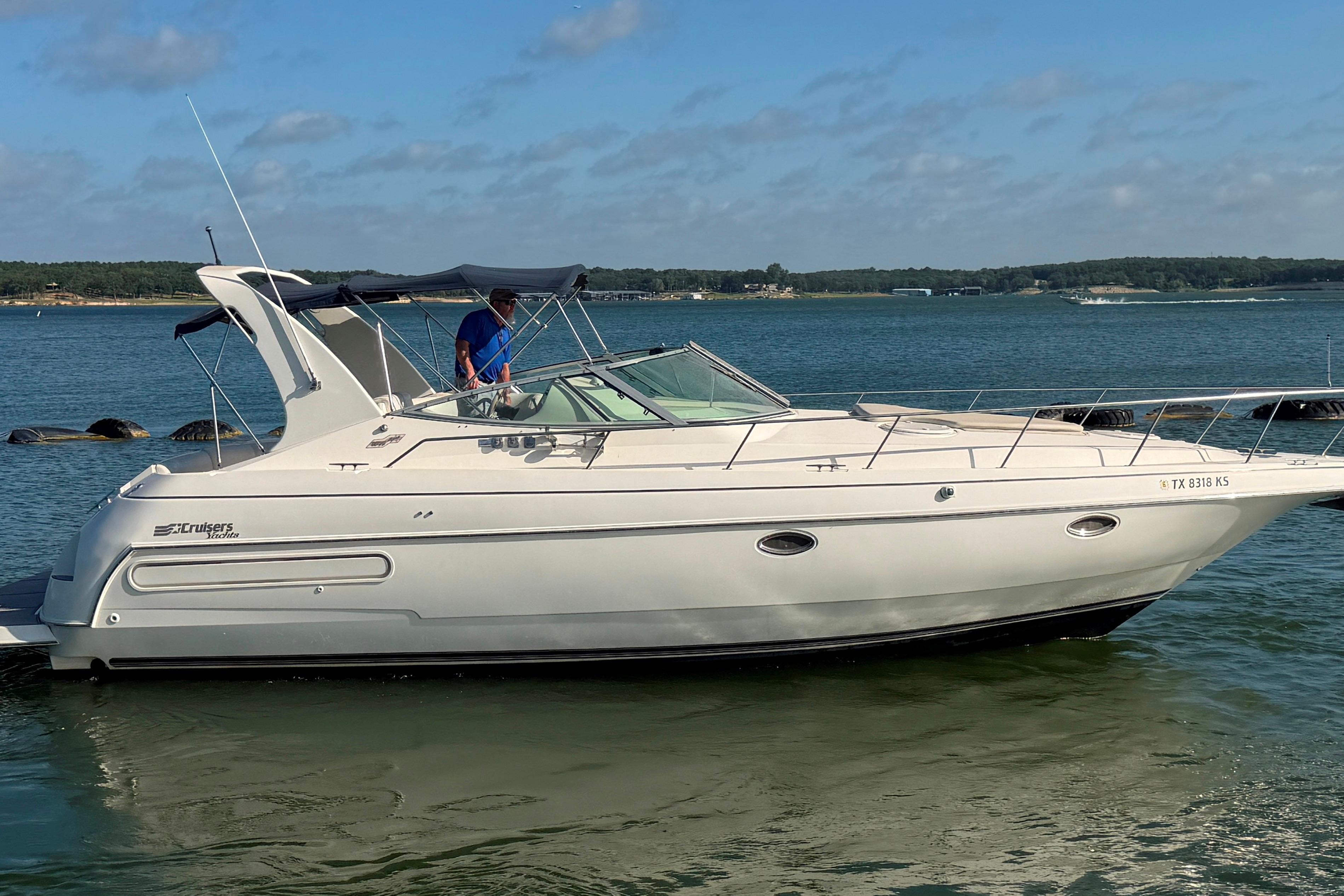 1997 Cruisers 3575 yacht on calm water, featuring sleek design and spacious deck.