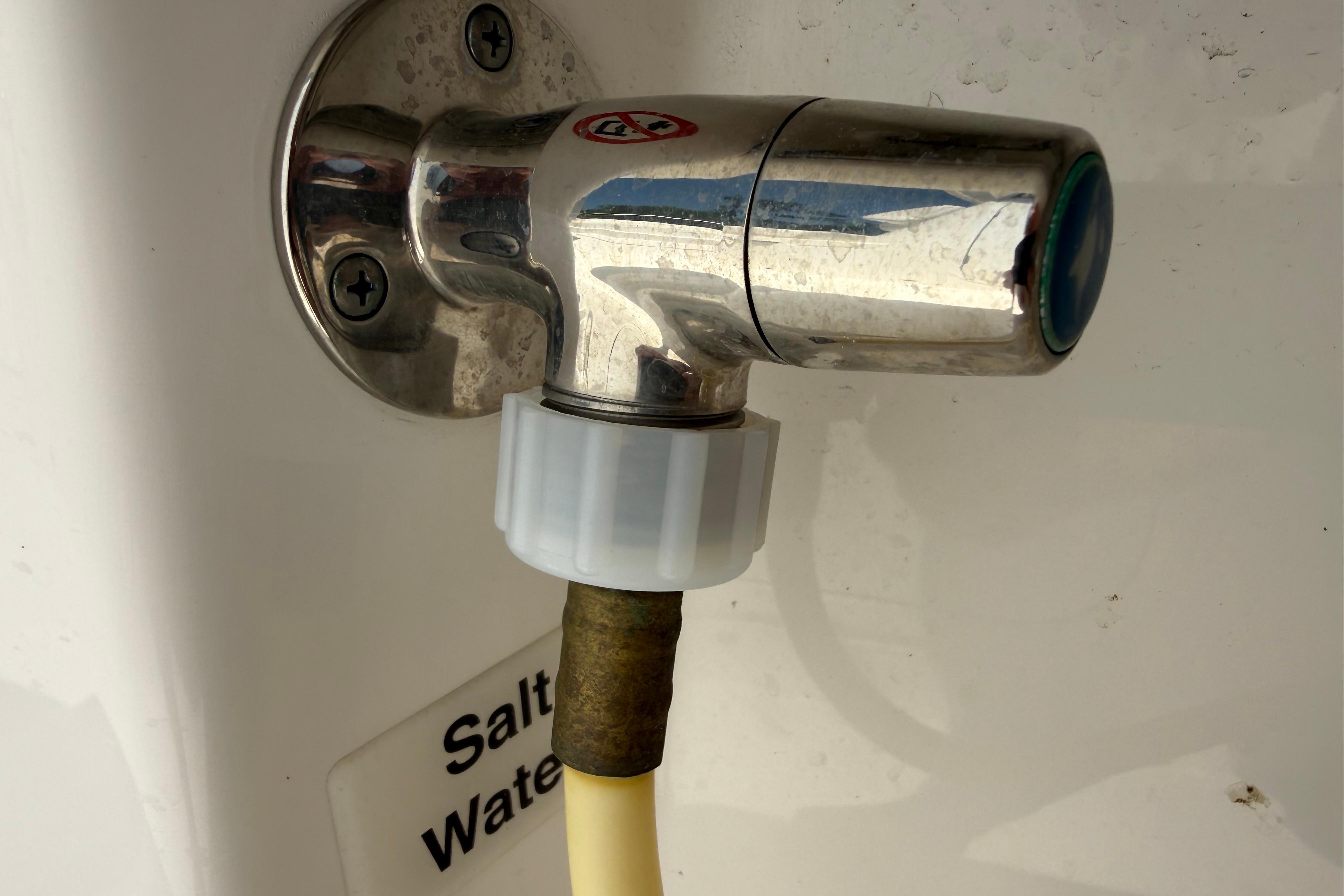 Saltwater faucet on 2023 Regulator 26XO boat, featuring a metal and plastic connection.
