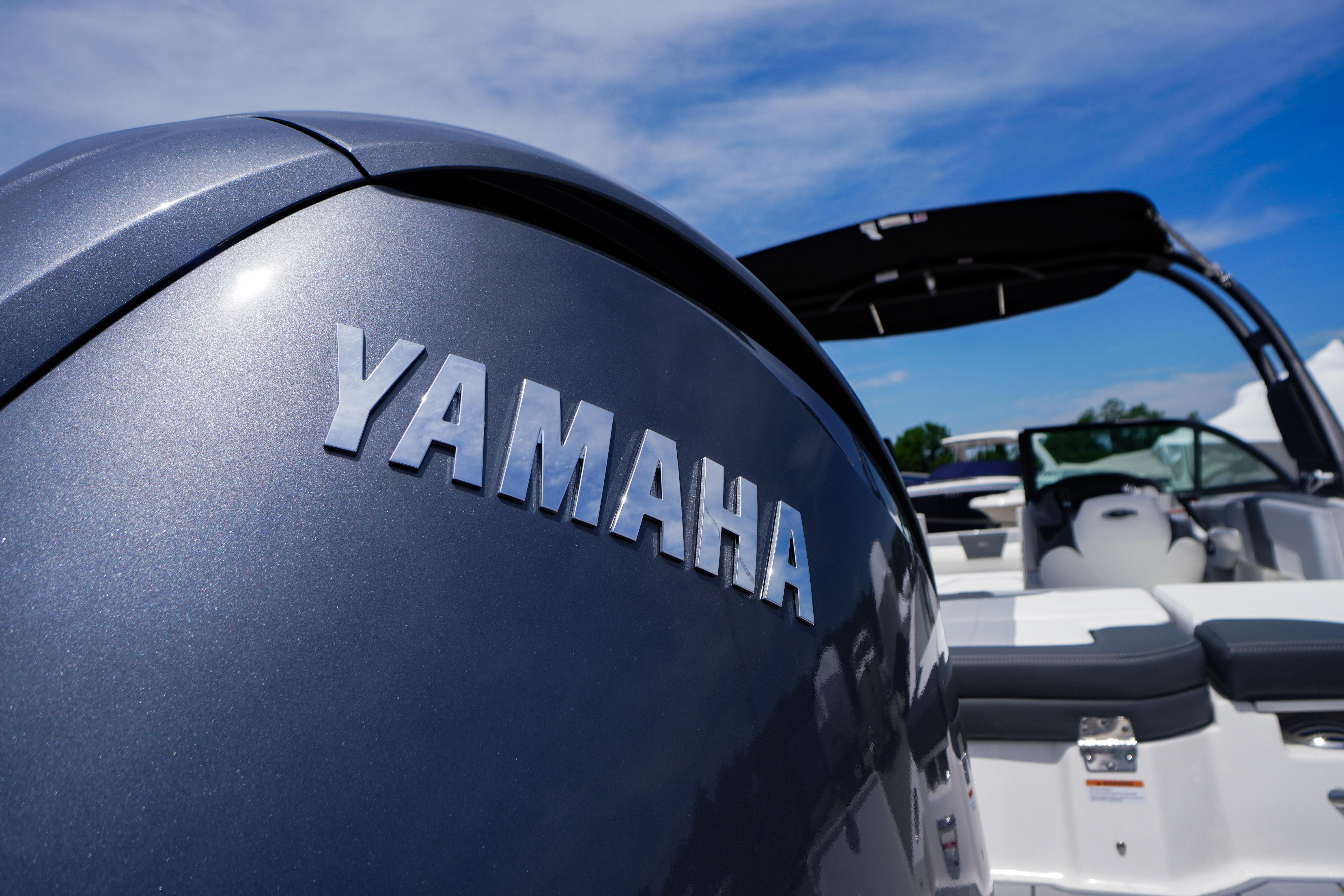 2026 Chaparral 23 SSi OB boat with Yamaha outboard motor under clear blue sky.