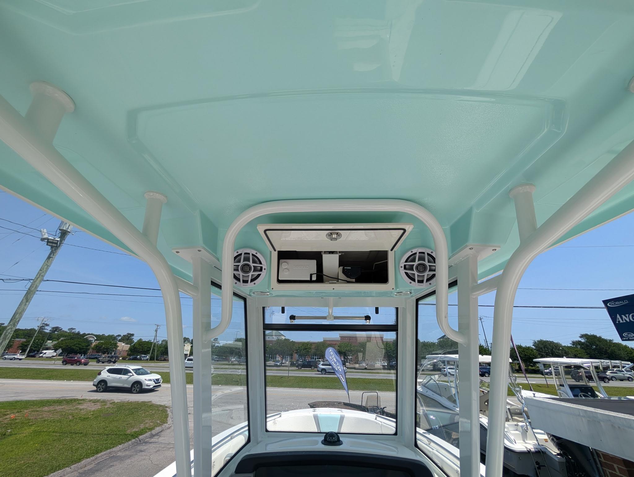 2025 Robalo R250 Center Console boat interior with speakers and storage.